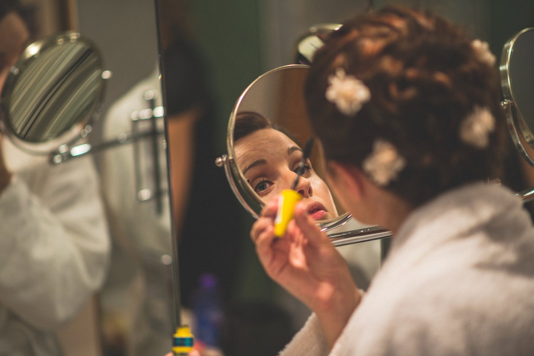 Bride applying her mascara at the Hurlingham Club