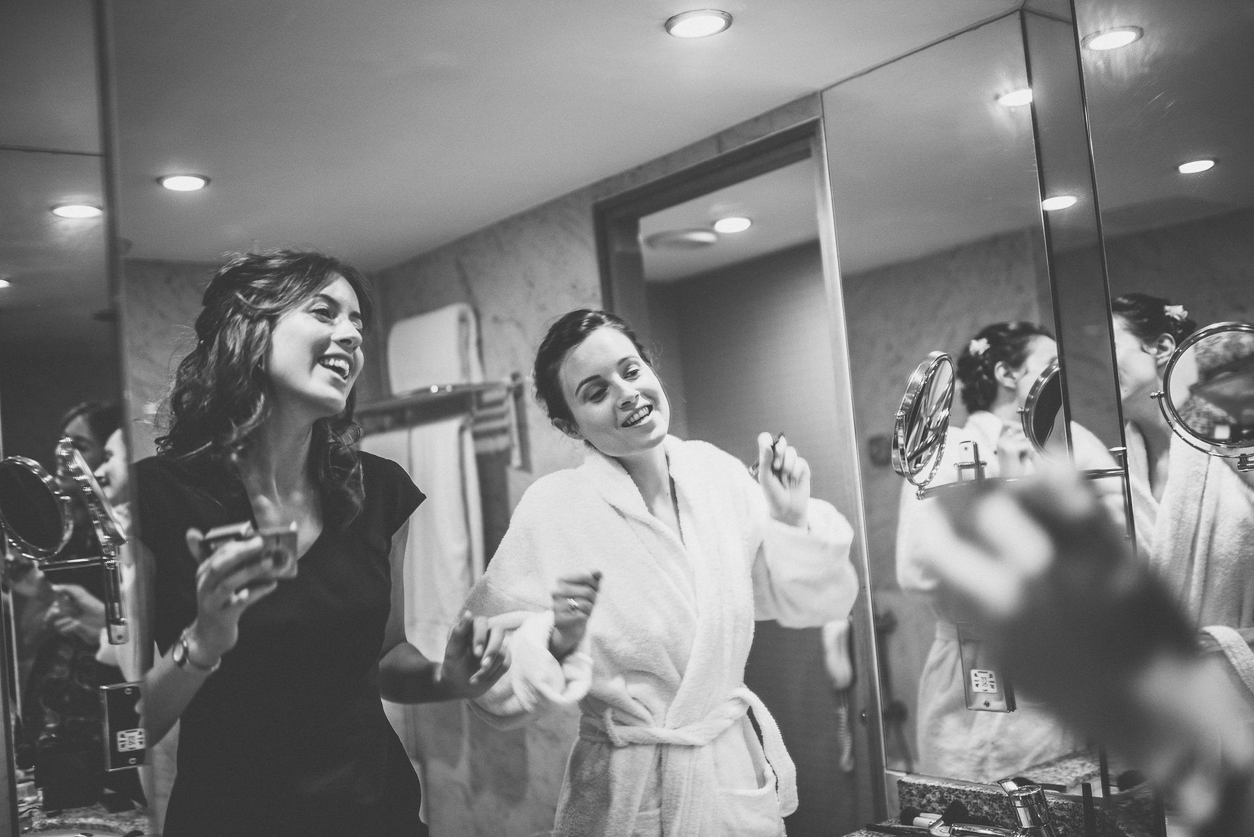 Bride and bridesmaid singing as they prepare for her Hurlingham Club Glamorous Music Themed Chelsea Wedding