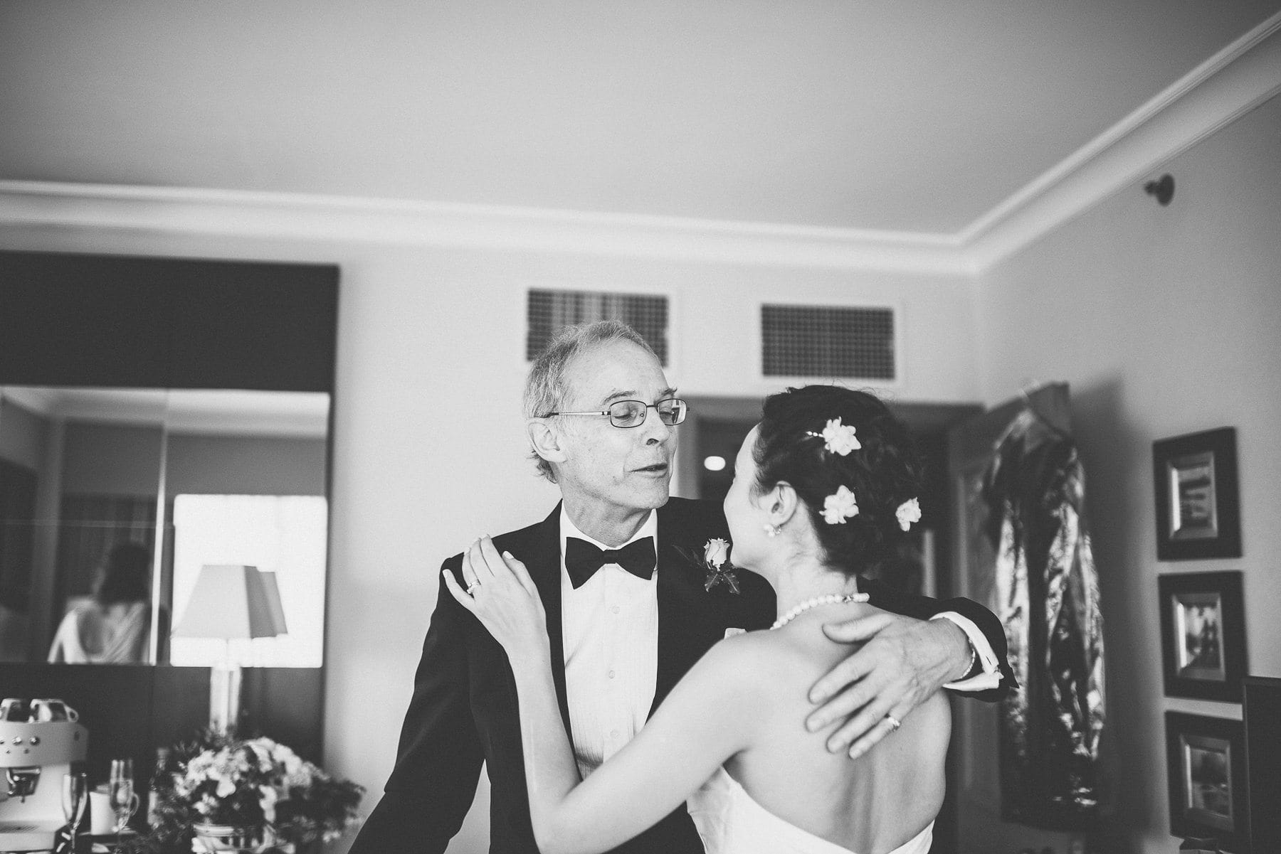 Father of the bride kissing his daughter as he sees her ready for the first time at the Chelsea Harbour Hotel