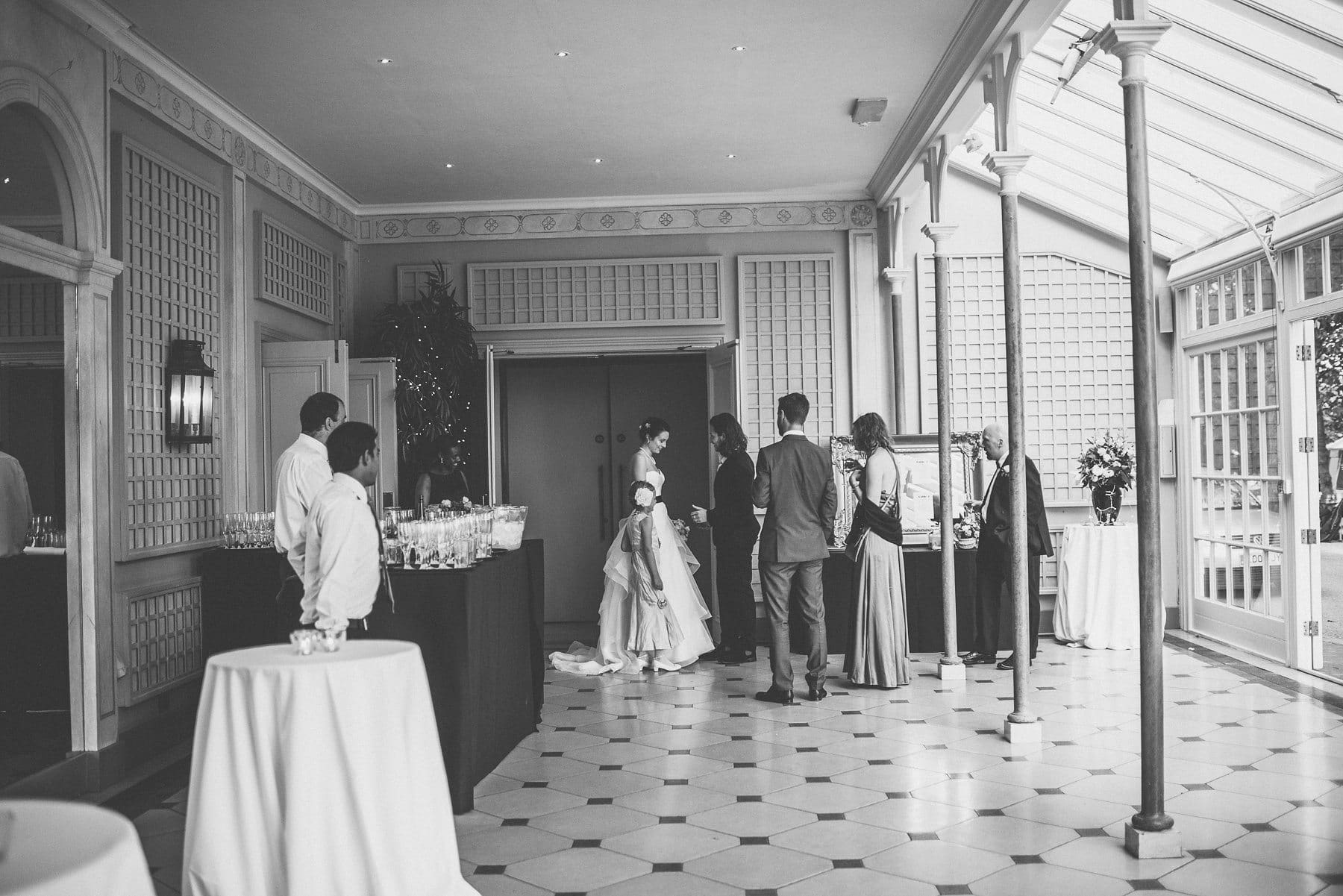 Groom greeting his Bride as she arrives in the Hurlingham Club Conservatory for their glamorous music themed Chelsea wedding reception