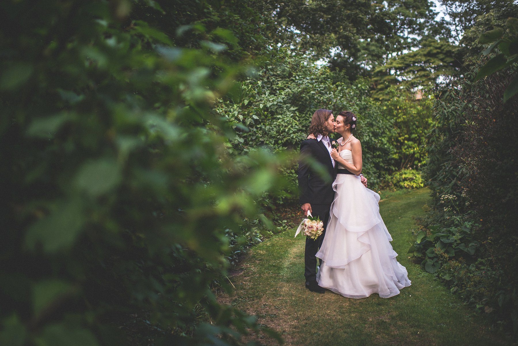 Bride and groom kissing at the Hurlingham Club grounds