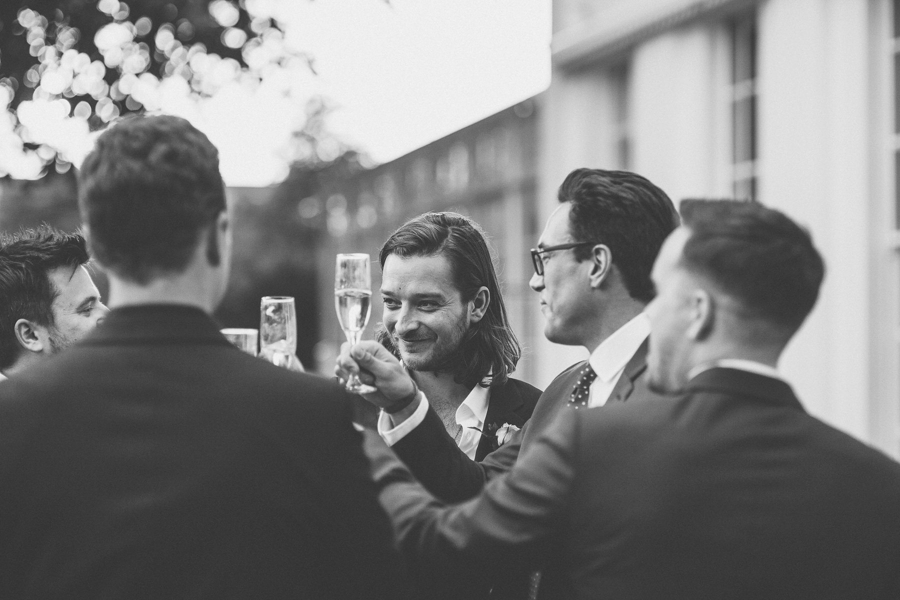 Groom and groomsmen toasting in the Hurlingham Club wedding grounds