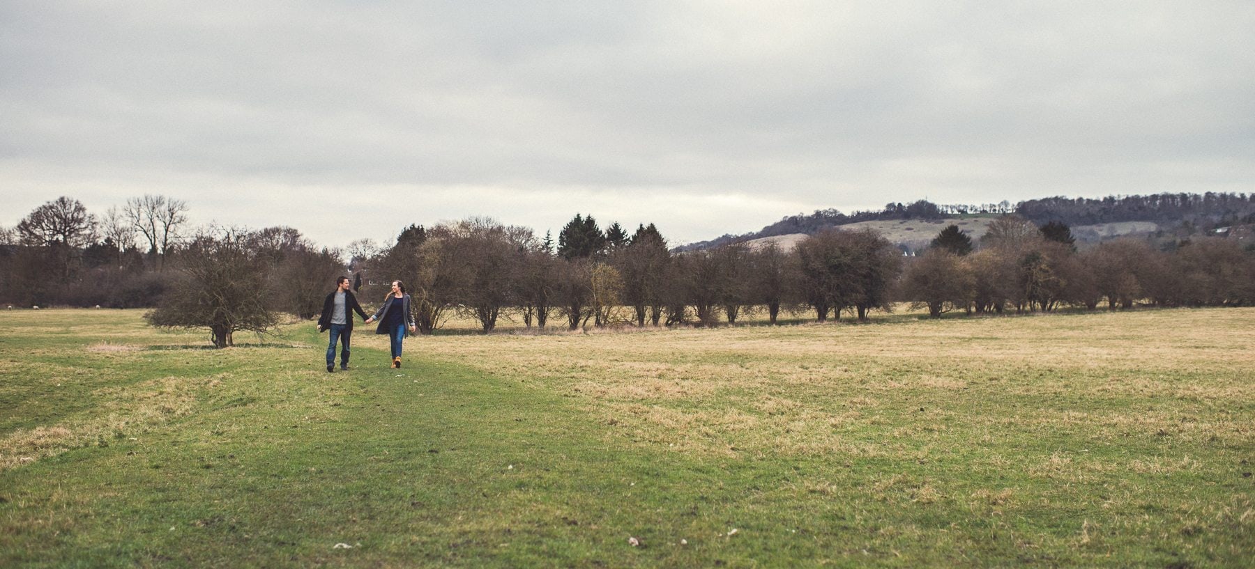 Couple walking through the Kent Downs in front of St Julians Club