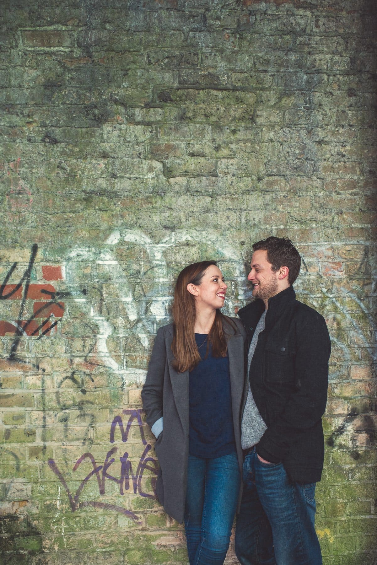 Kent Downs romantic relaxed engagement shoot couple standing in a tunnel with graffitti