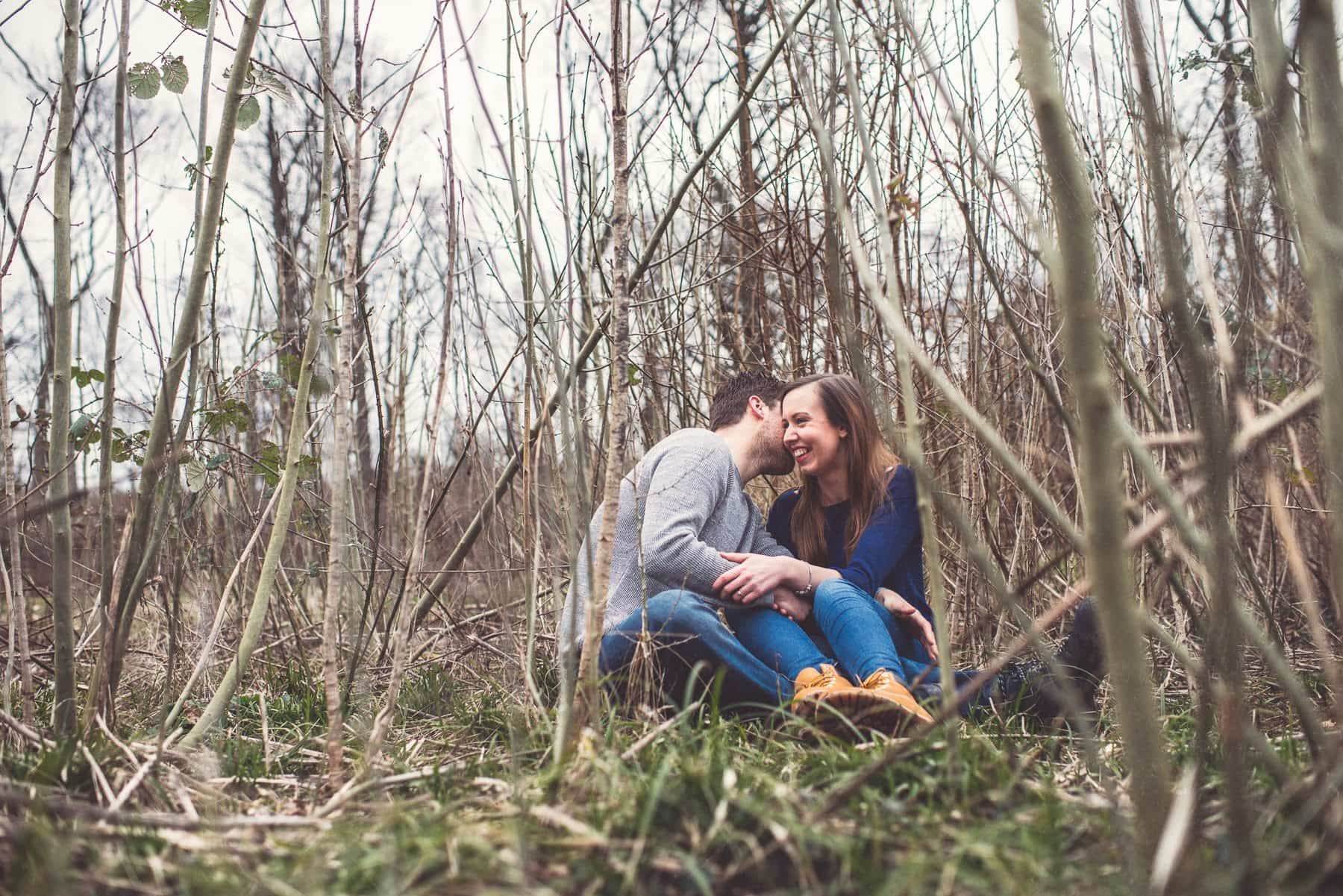 Couple laughing in a bamboo field surrounded by twigs and bamboo by creative wedding photographer Maria Assia Photography