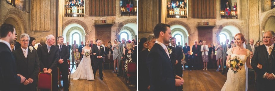 Bride walking into her candle lit wedding ceremony at Hedingham Castle