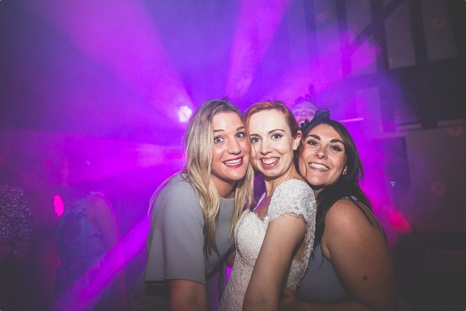 Bride posing with her friends at a fun Smeetham Hall Barn wedding