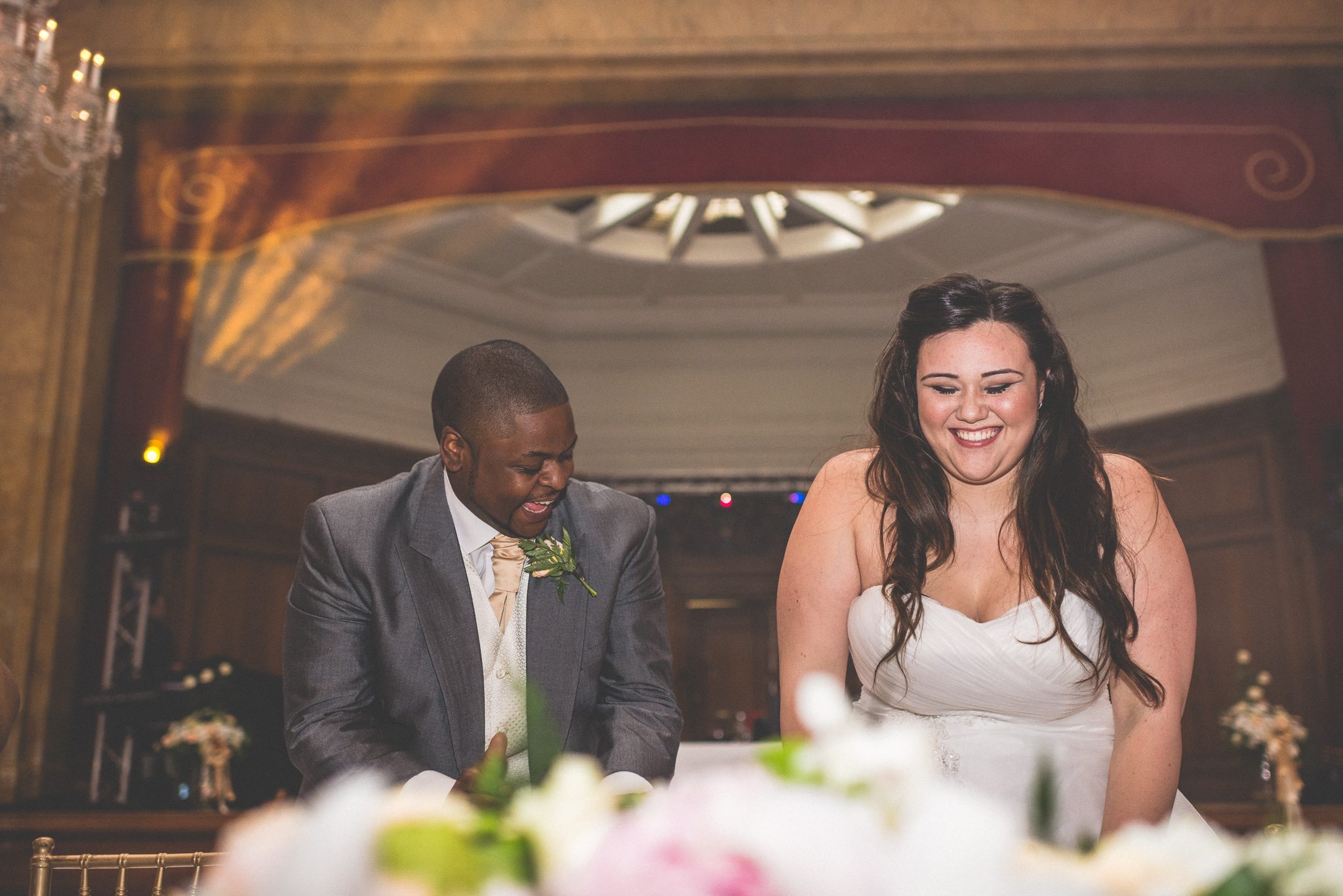 Bride and groom laughing during the speeches