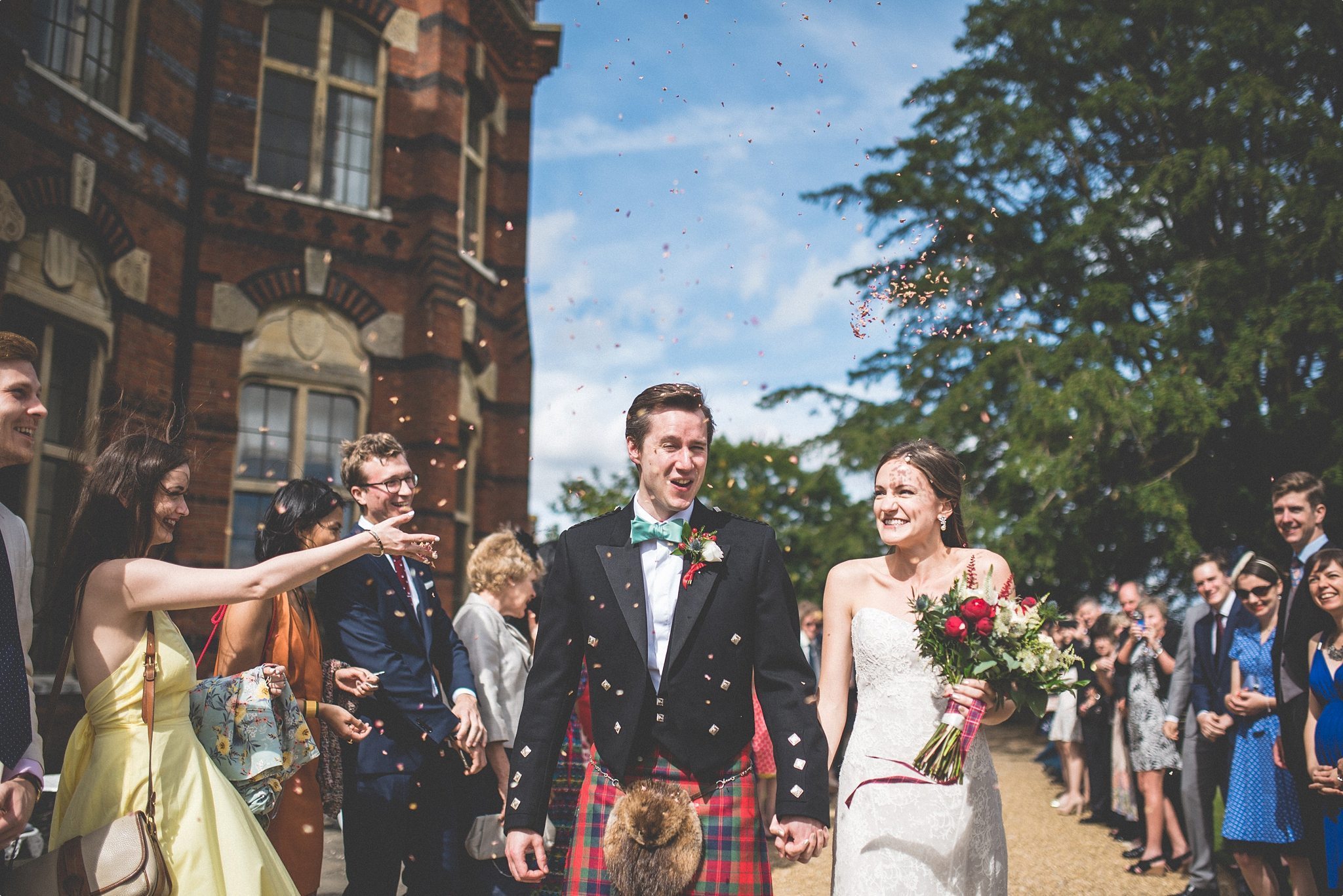 Elvetham Hotel Bride and Groom walking through wedding confetti