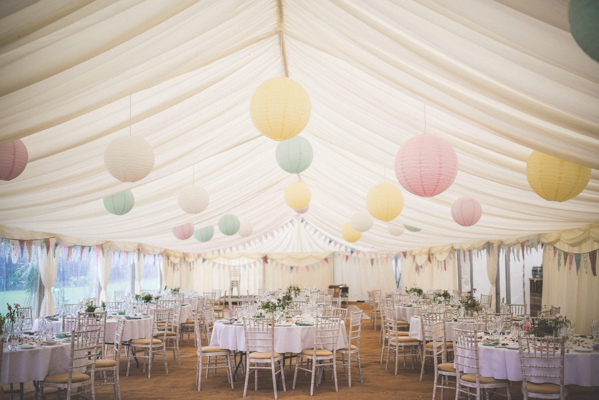 Smedmore House wedding marquee decorated with hanging lanterns in pastel hues