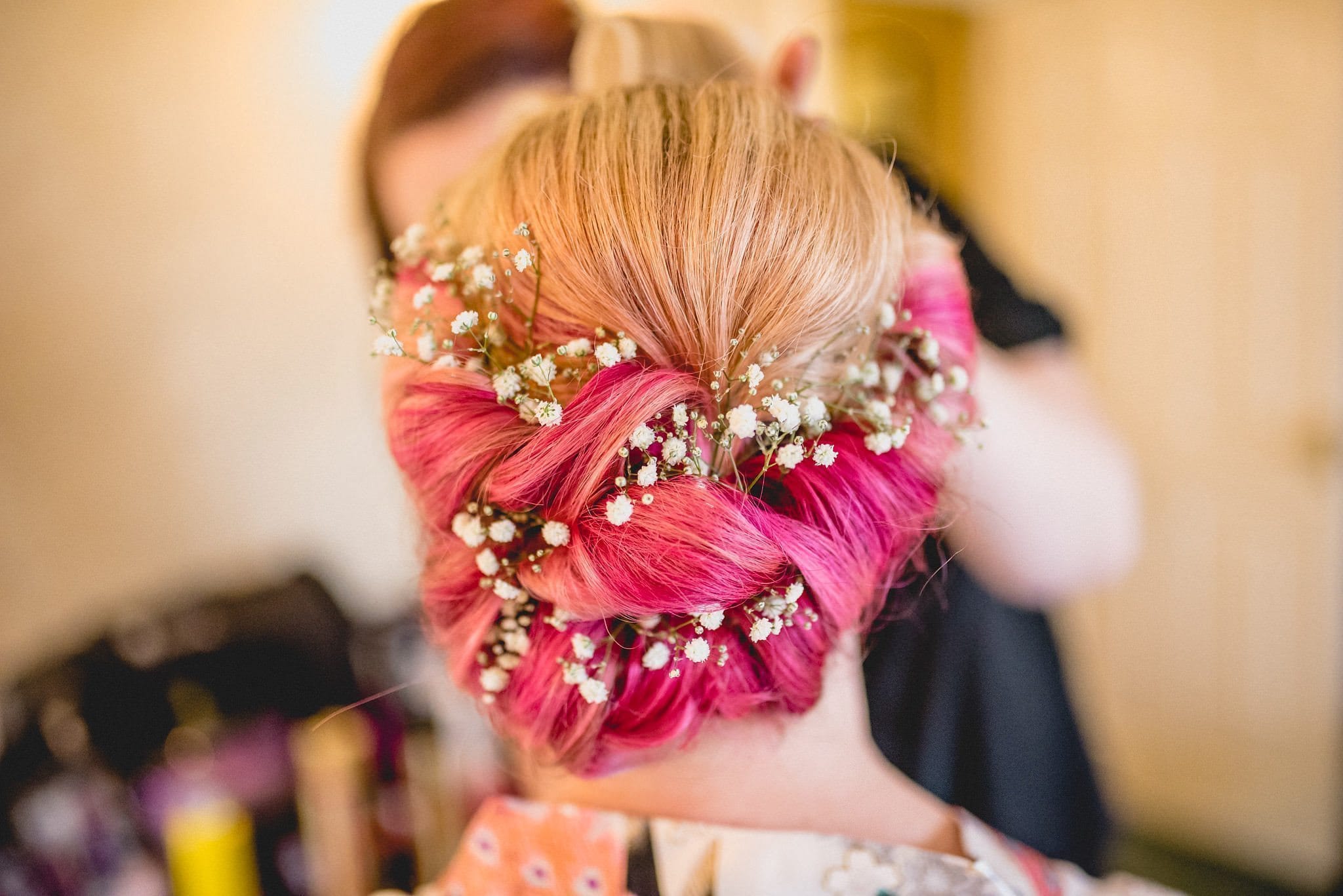 Bride's pink hair threaded with gypsophila for her quirky Birtsmorton Court wedding