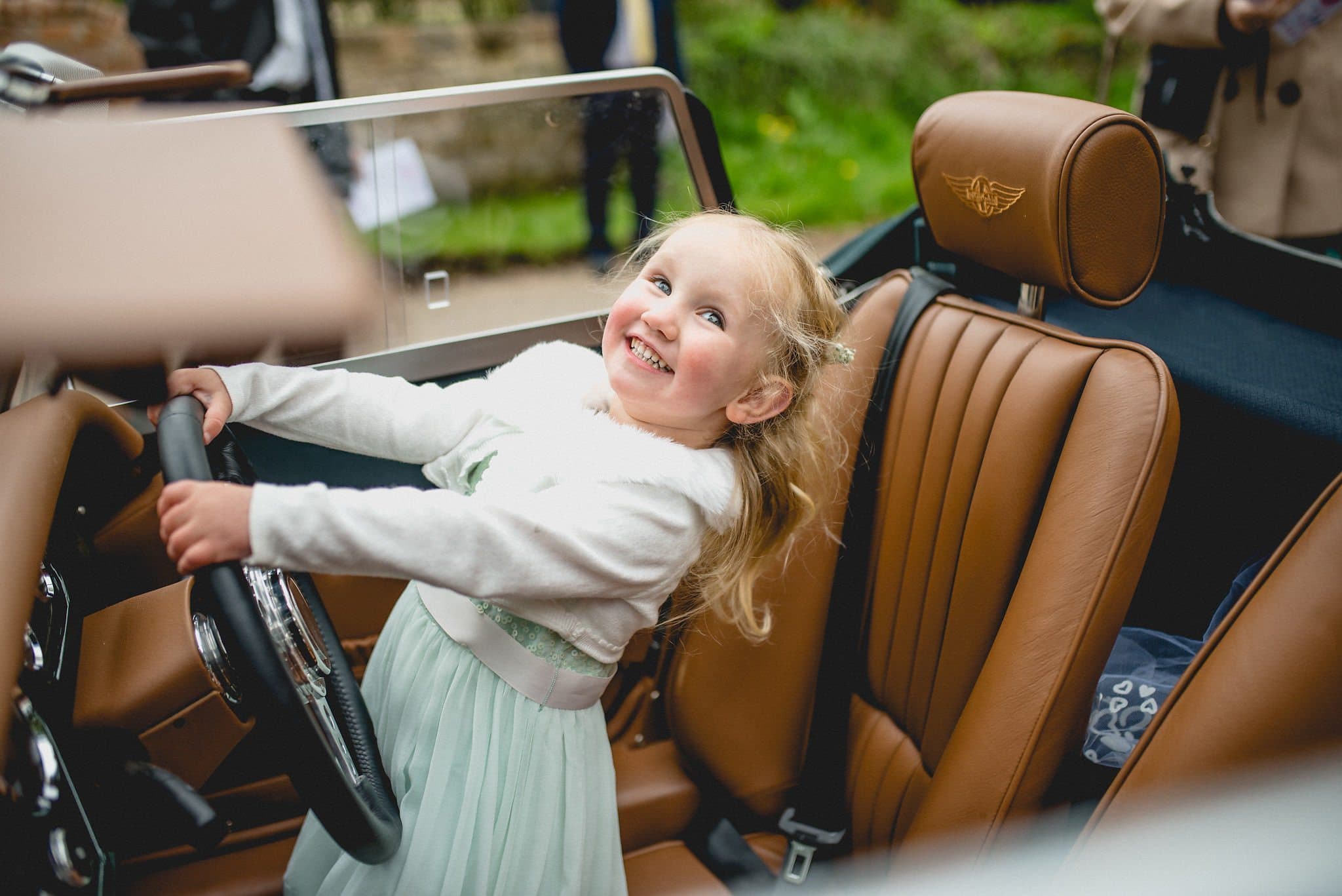 Bride's daughter pretends to drive the wedding car