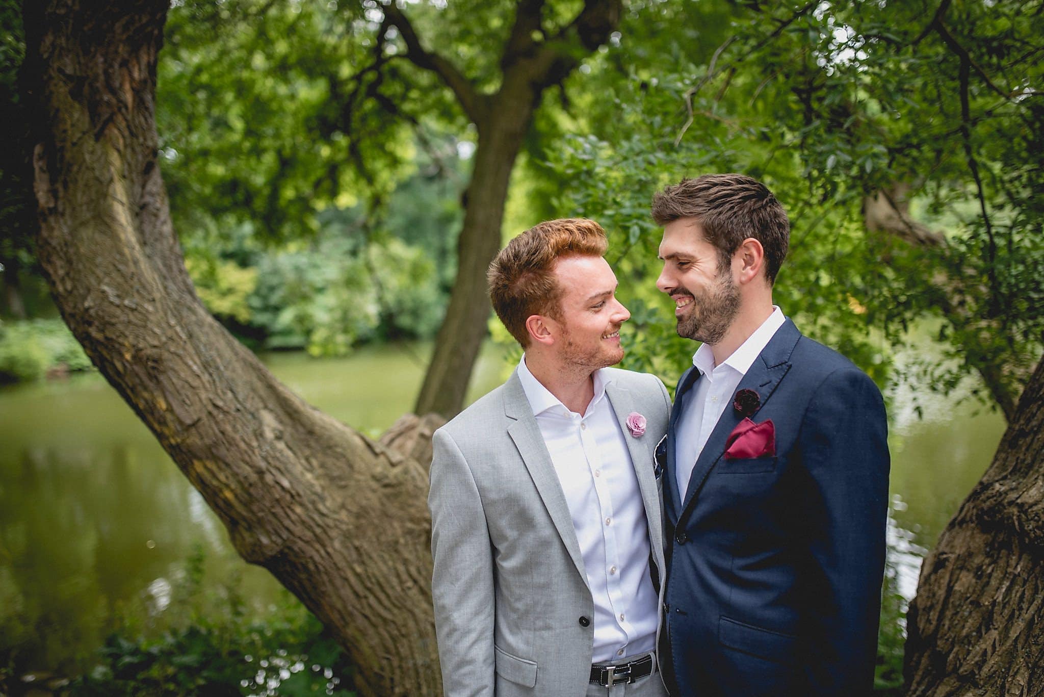 Two grooms smile together during their Copenhagen elopement