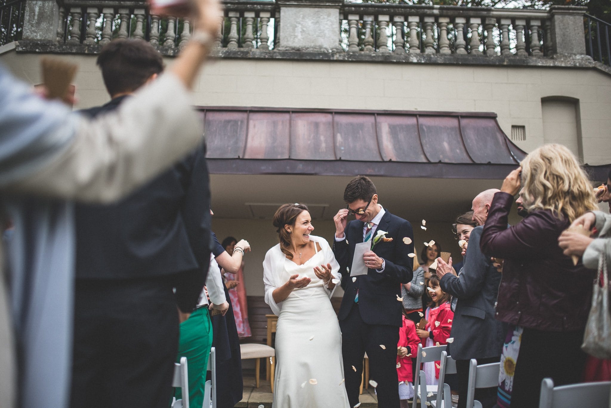 Wedding confetti getting stuck in the Groom's glasses at the Hampstead Pergola