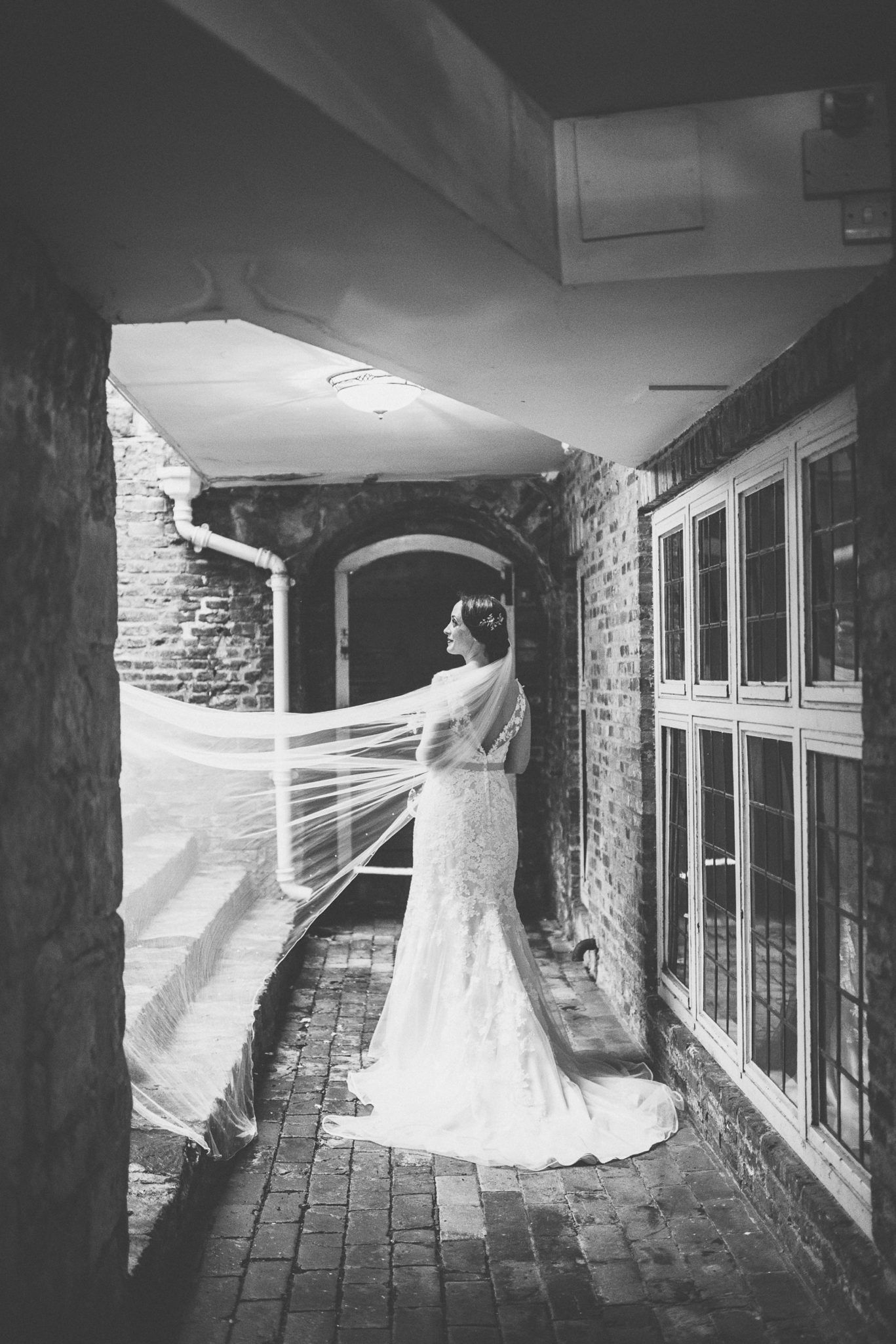 Brides veil blowing across the steps at Farnham Castle Keep