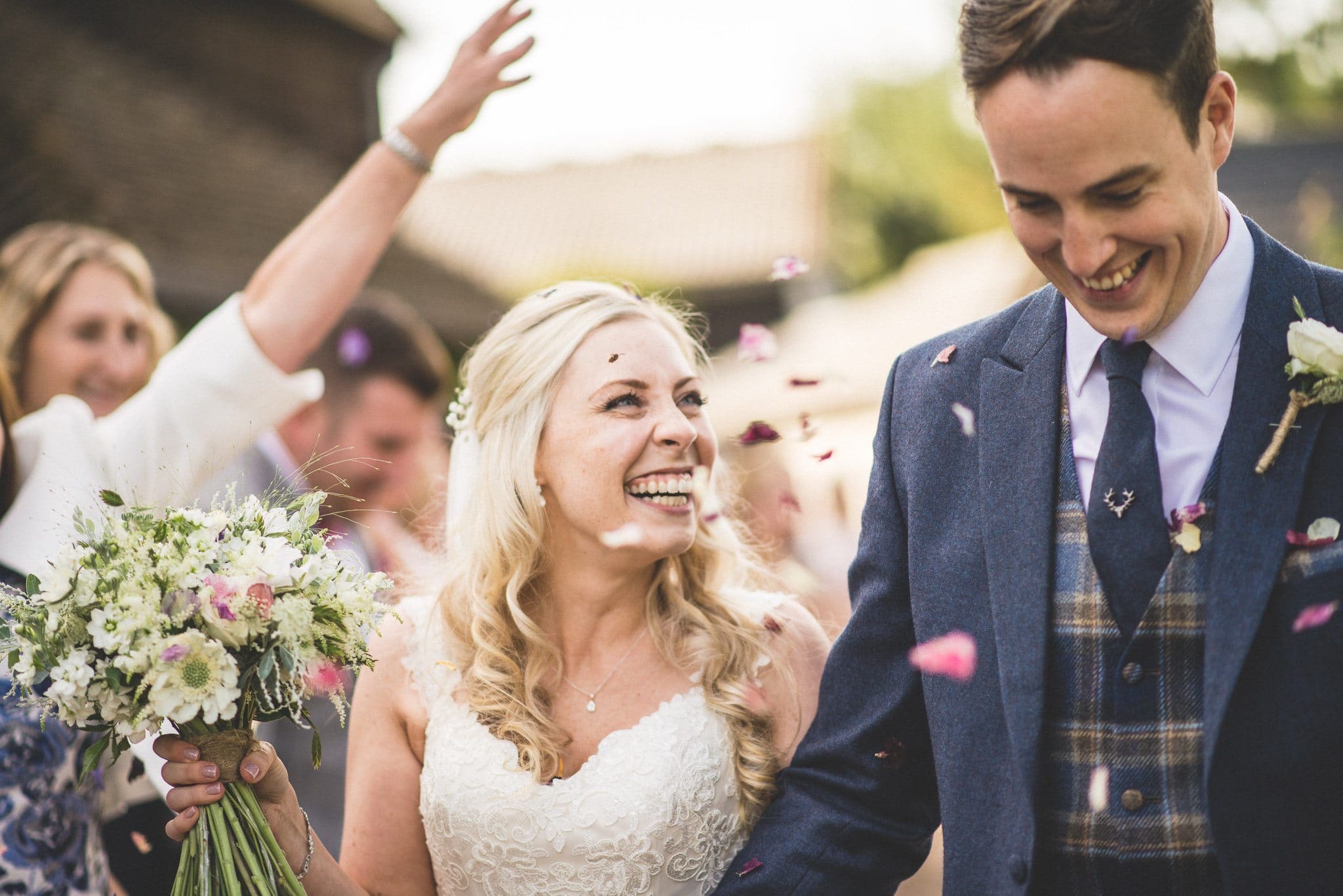 Emma looks at her groom and laughs as the confetti keeps on coming!