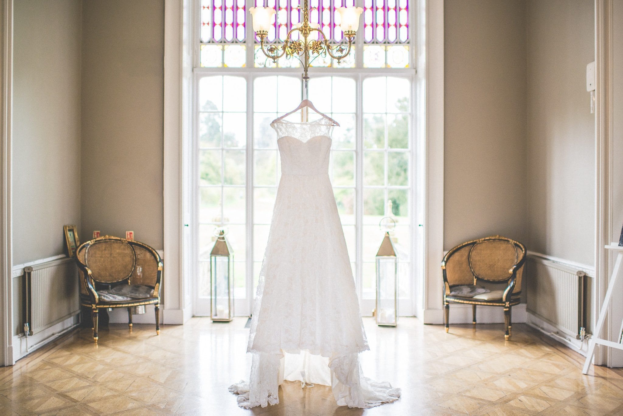 Jasmin's dress hangs from a chandelier on the morning of her emotional Nonsuch Mansion wedding