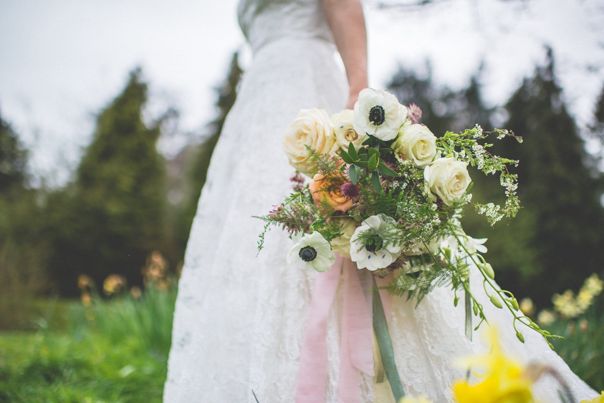 Bridal bouquet of anemones & roses, tied with pale pink, sage green silk ribbons