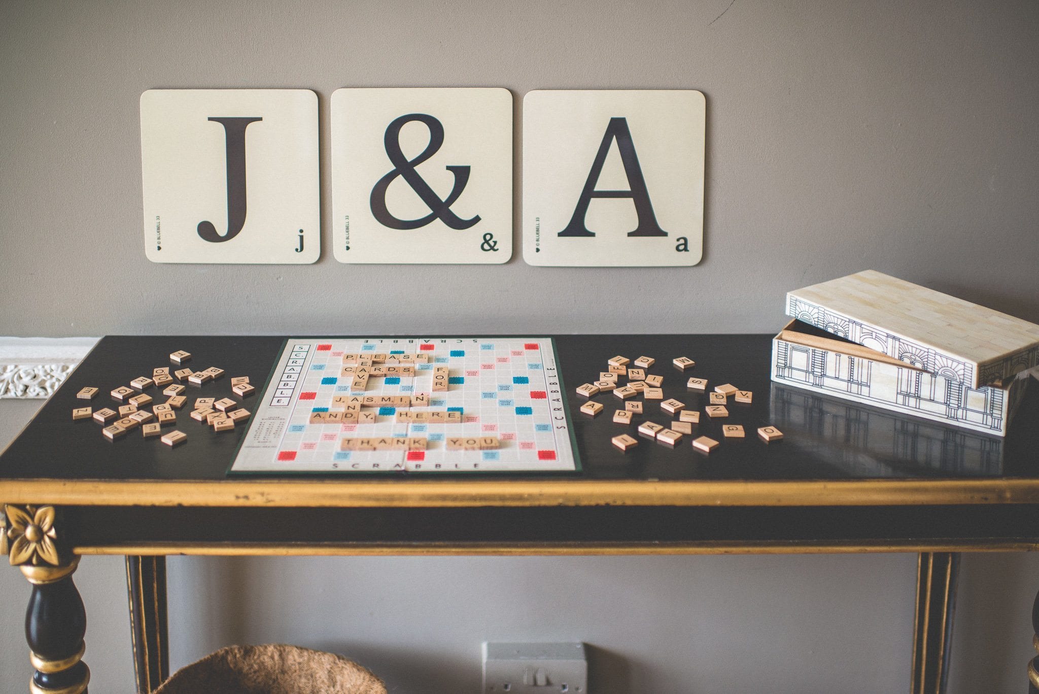 Jasmin and Andy's gift and card table, with instructions spelled out in Scrabble tiles and large J & A scrabble tiles on the wall behind it