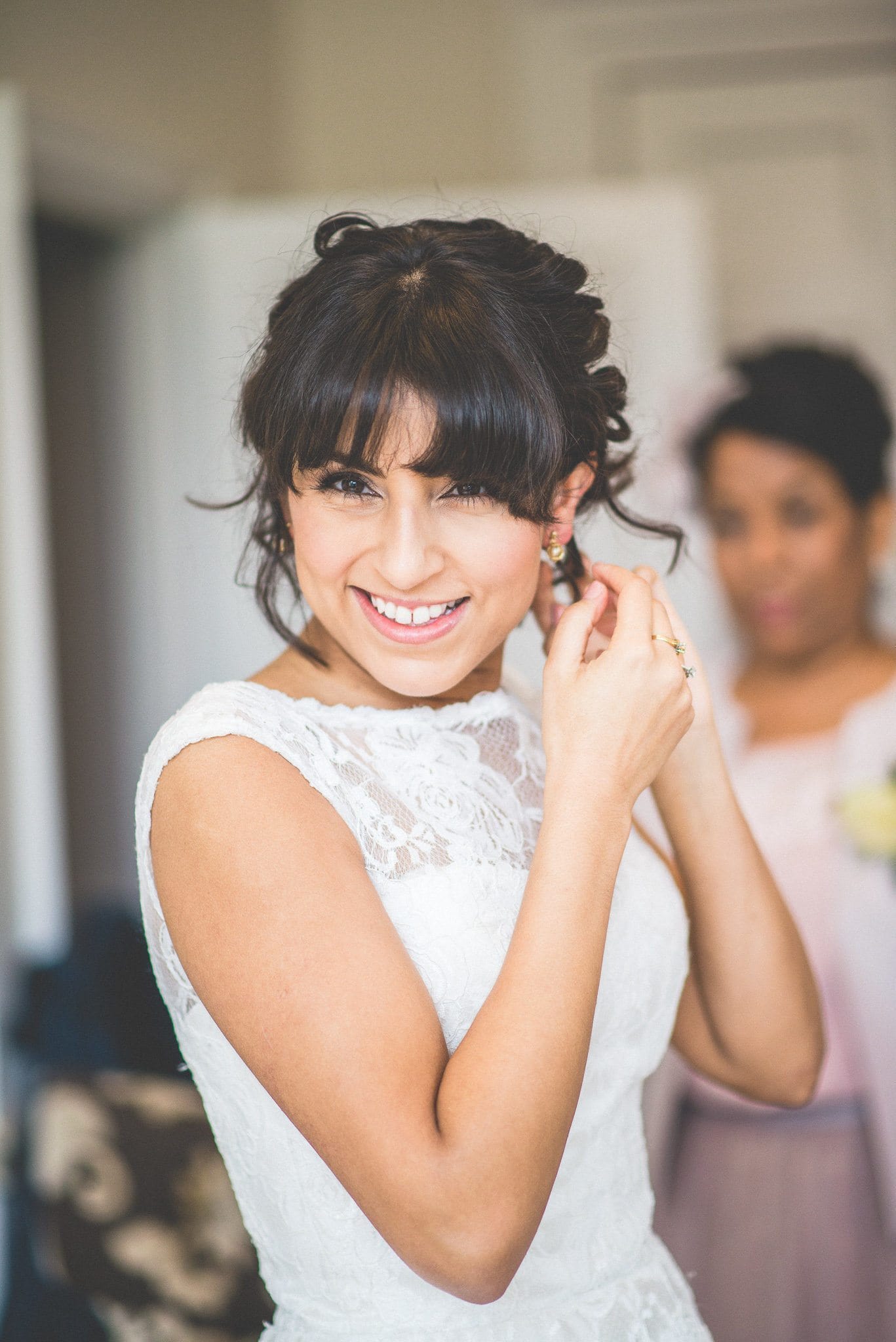 Jasmin fastens her earring as she gets ready for her emotional Nonsuch Mansion wedding