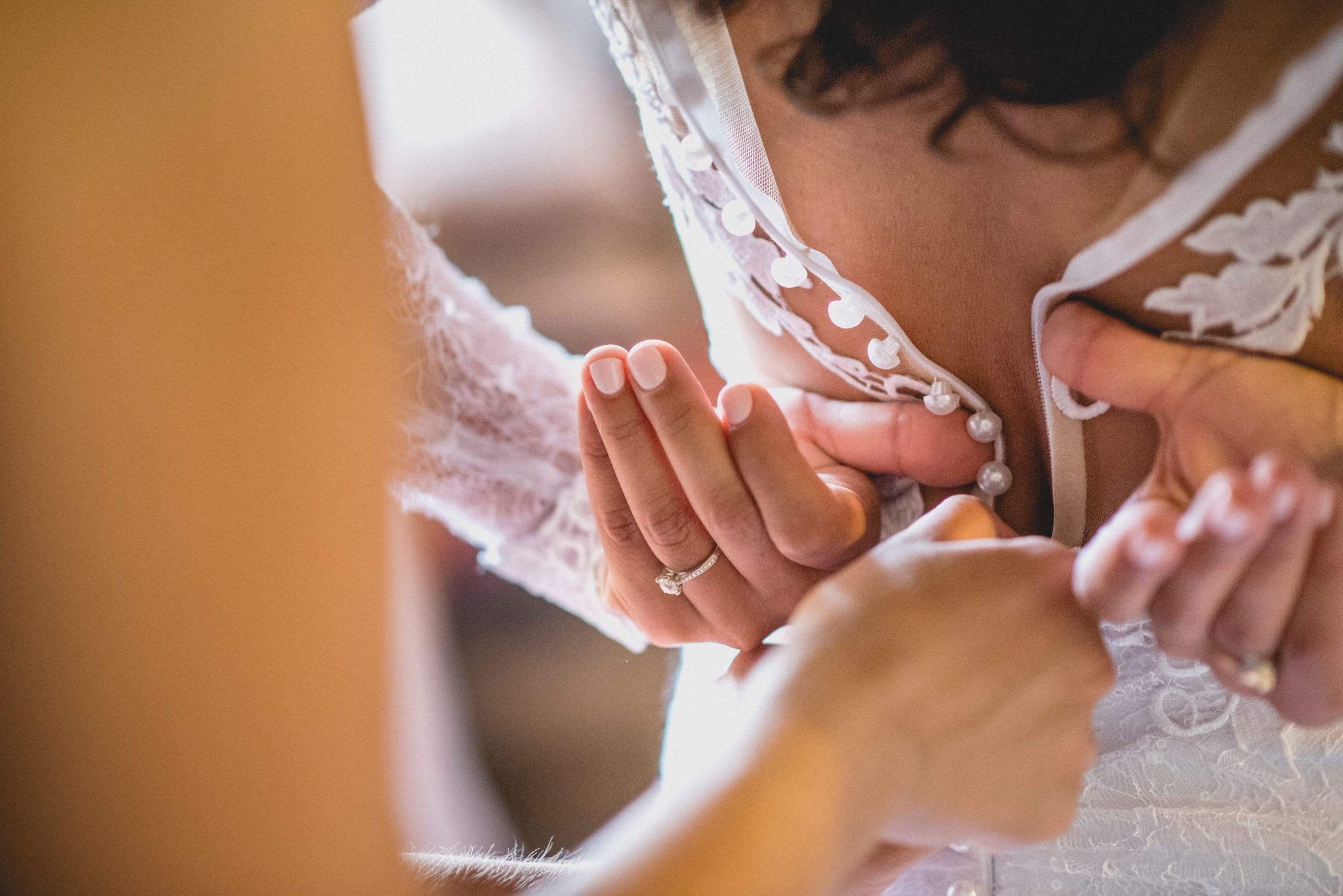 Bride's wedding dress is buttoned up at her Luxury Marrakech destination wedding