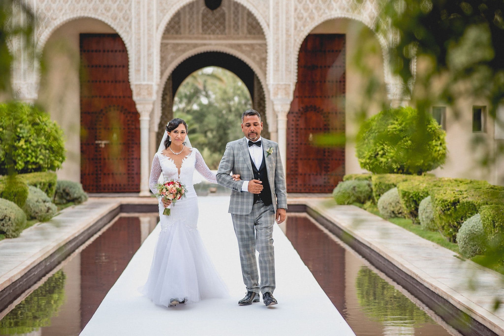 Bride walking down the aisle with her dad at Ksar Char Bagh