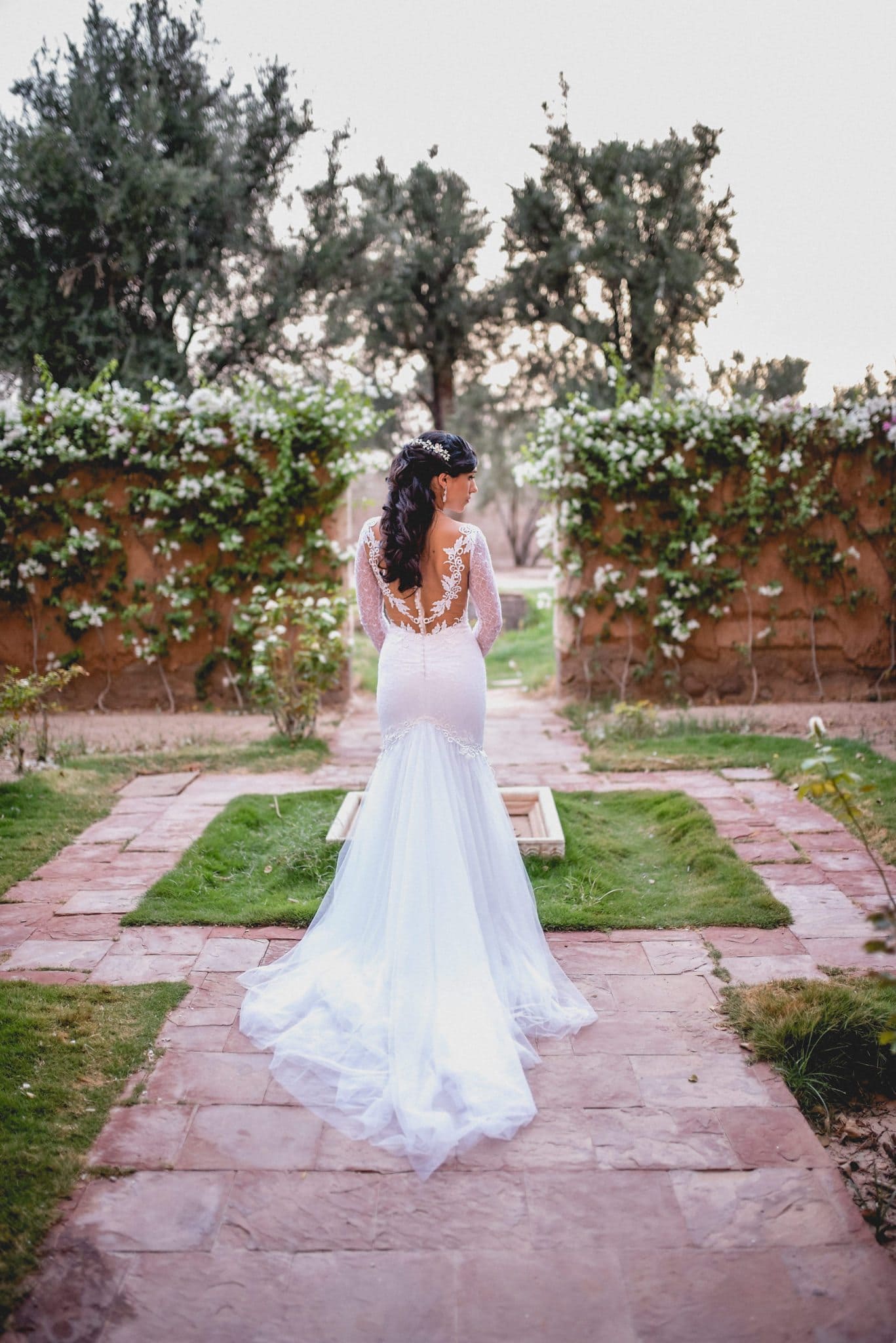 Bride turns in the walled garden at Ksar Char Bagh luxury hotel in Marrakech