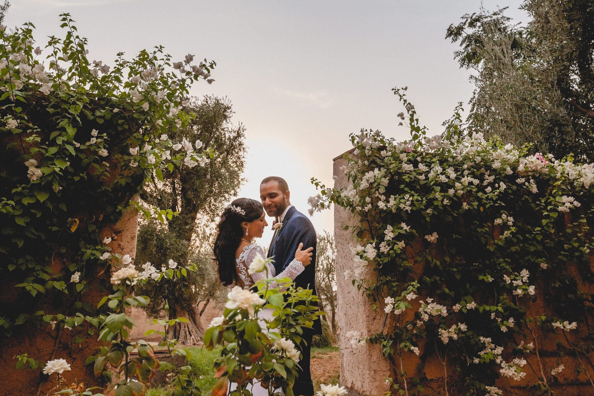 Luxury Marrakech Destination Wedding Bride and groom in the Ksar Char Bagh rose garden