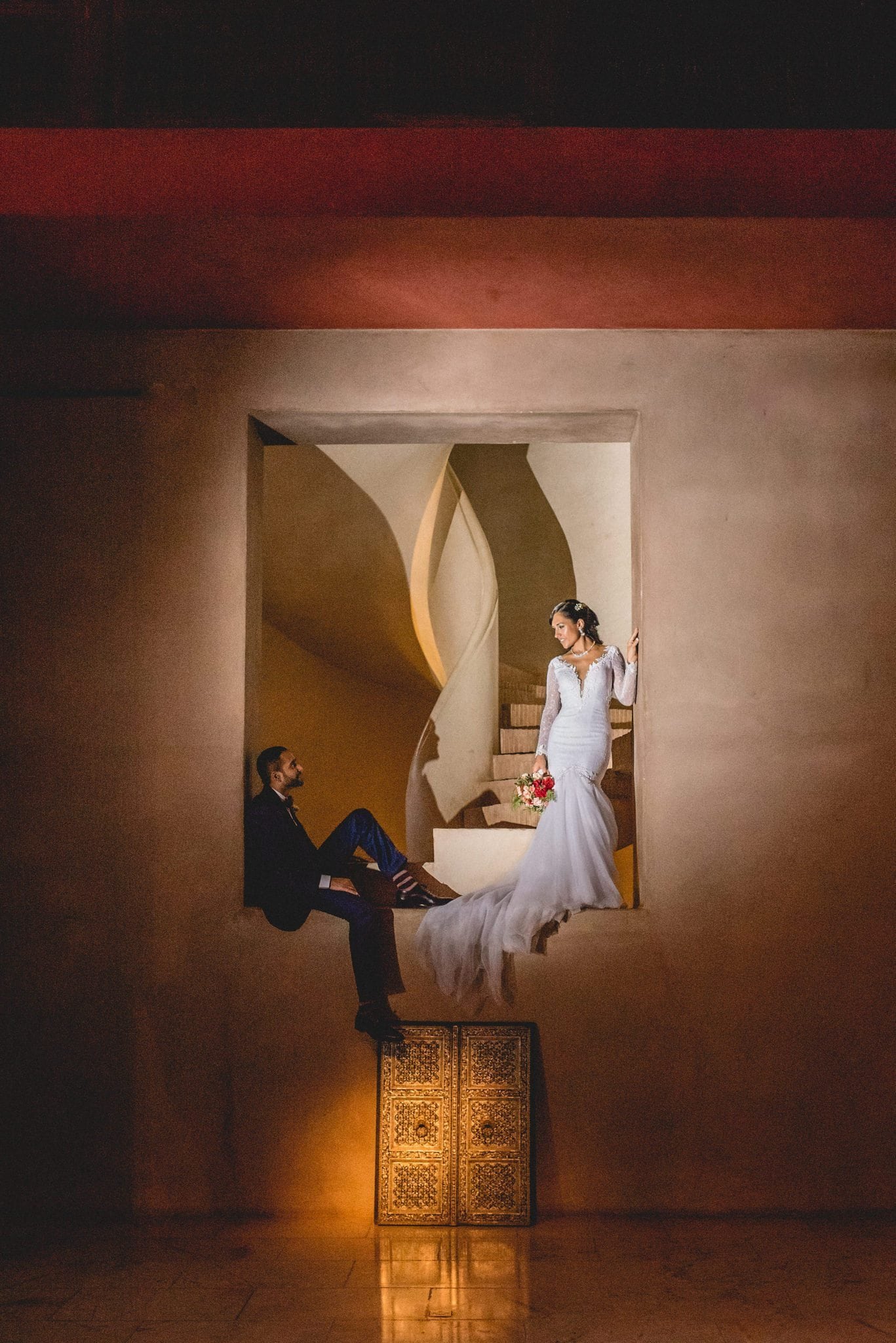 Dramatic shot of a Bride and groom at the base of the Ksar Char Bagh staircase 