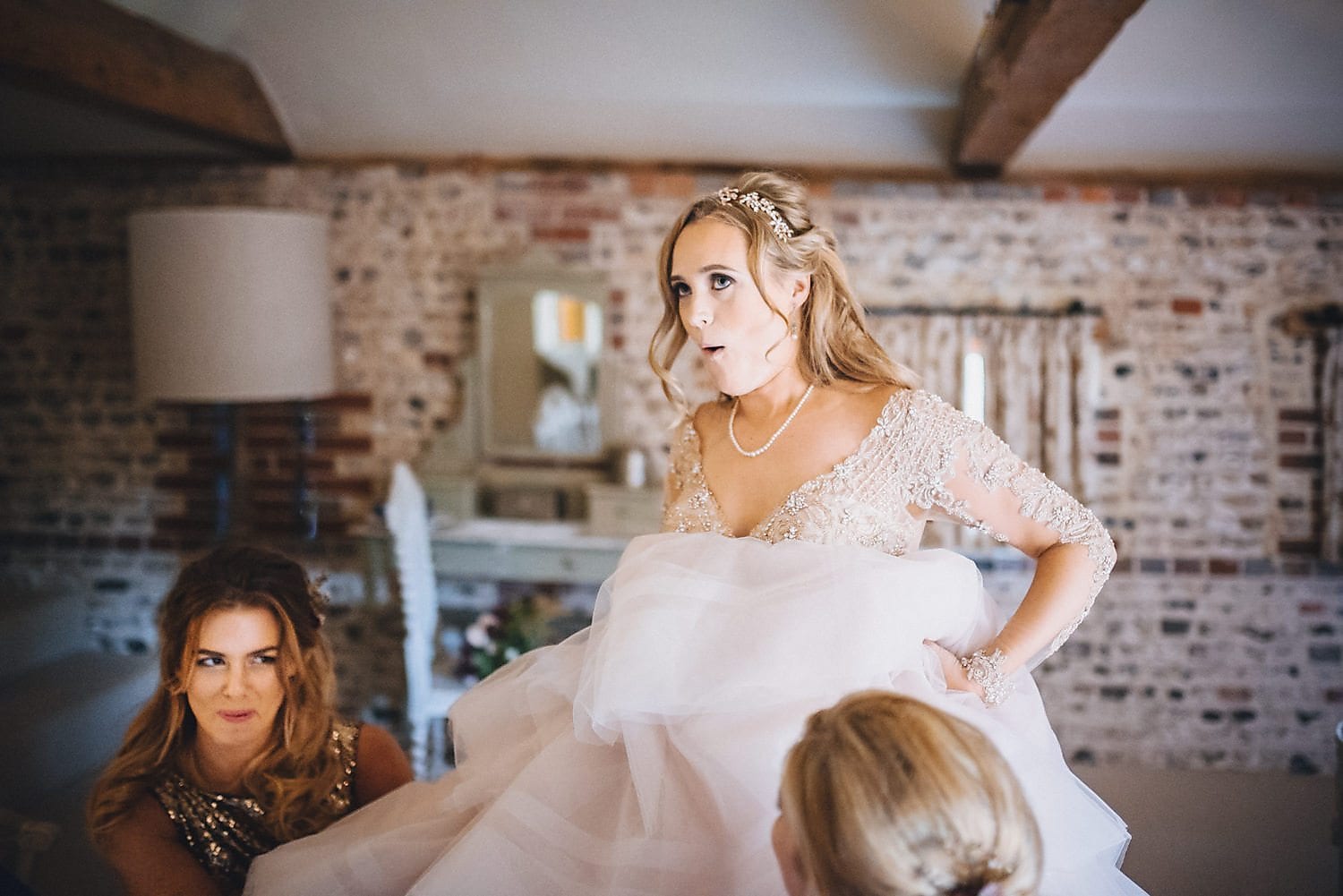 An action shot of the bride getting into her Martina Liana wedding gown