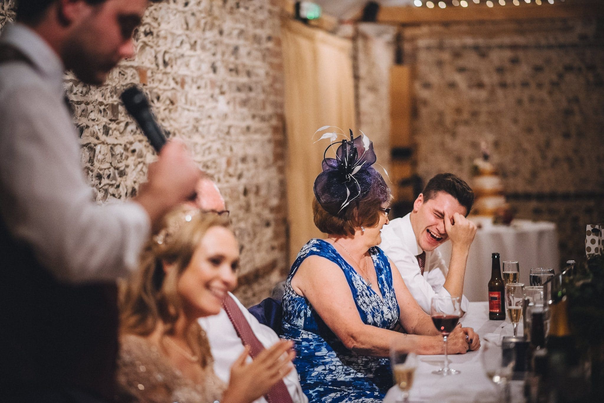 Bride's brother laughing at the wedding speeches