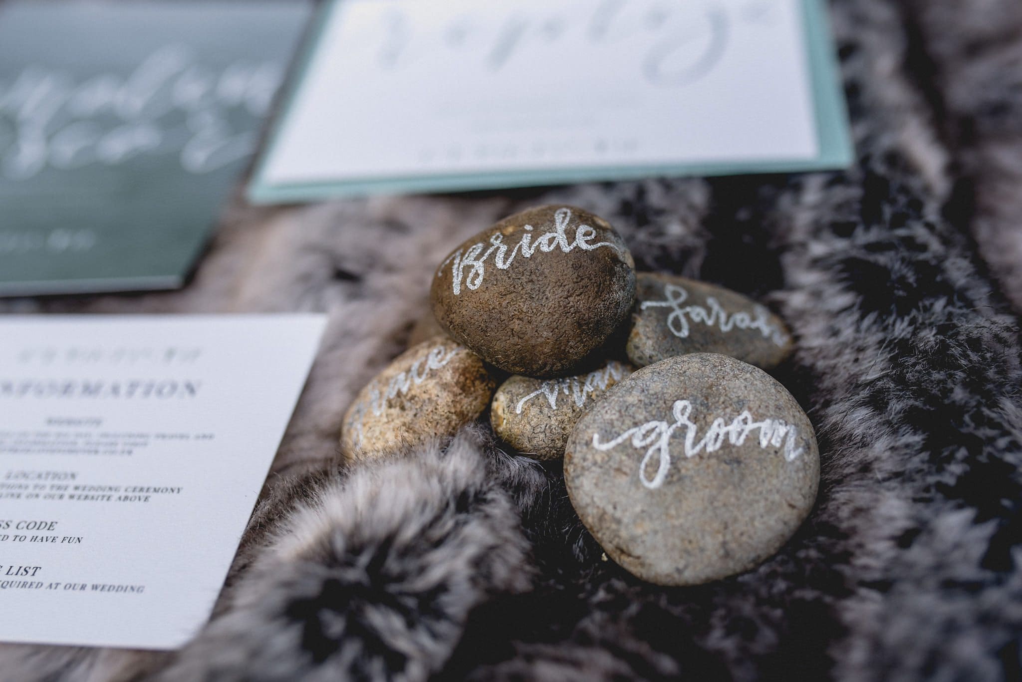 Close up of calligraphied pebbles on grey fur throw