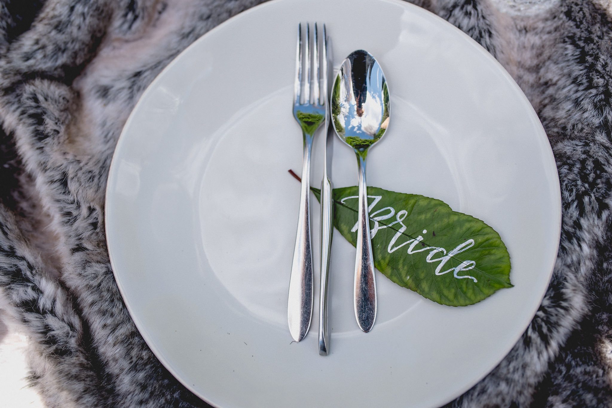 Close up of bride place setting with calligraphy on leaf