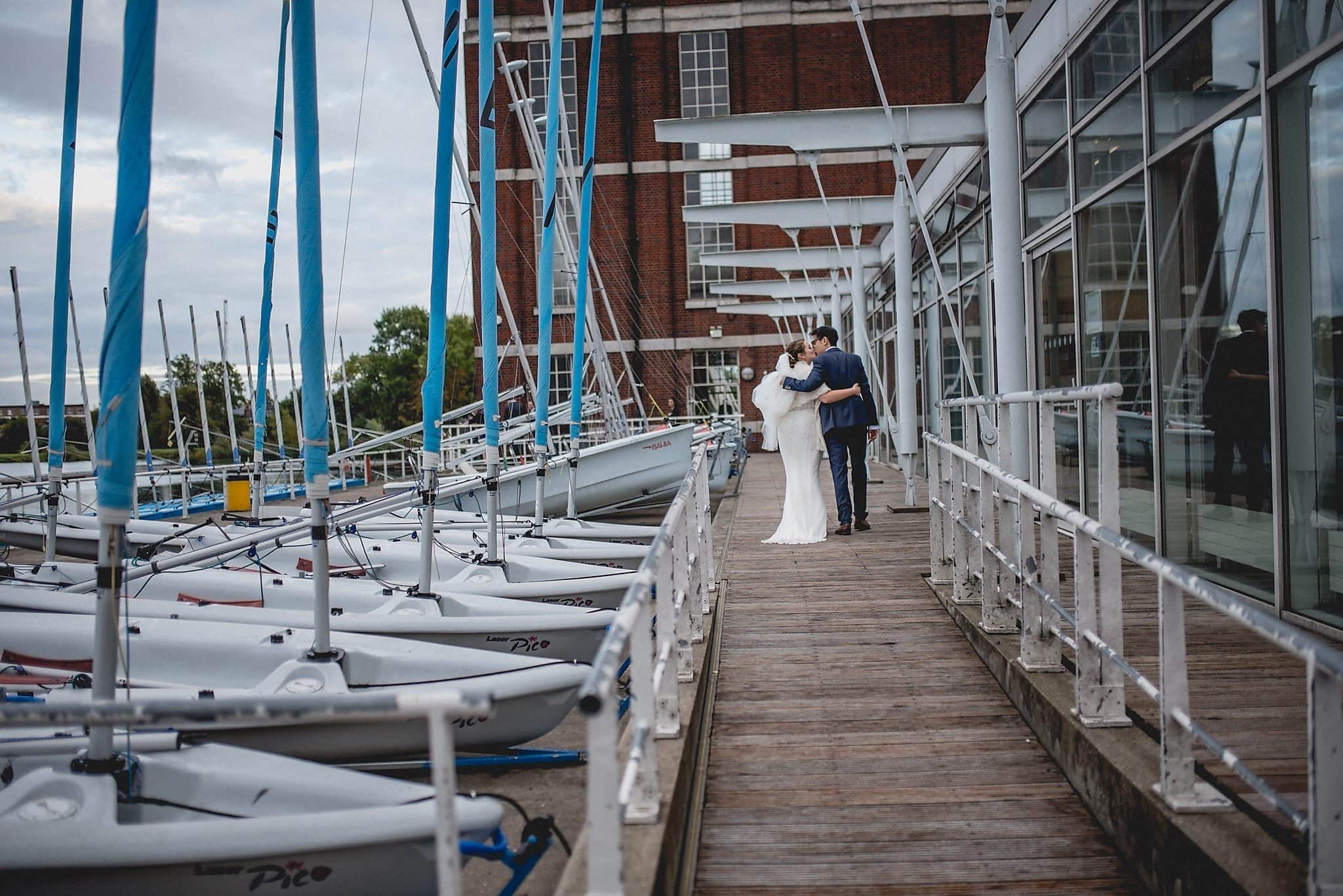 Bride and groom walking up the jetty to the West Reservoir Centre