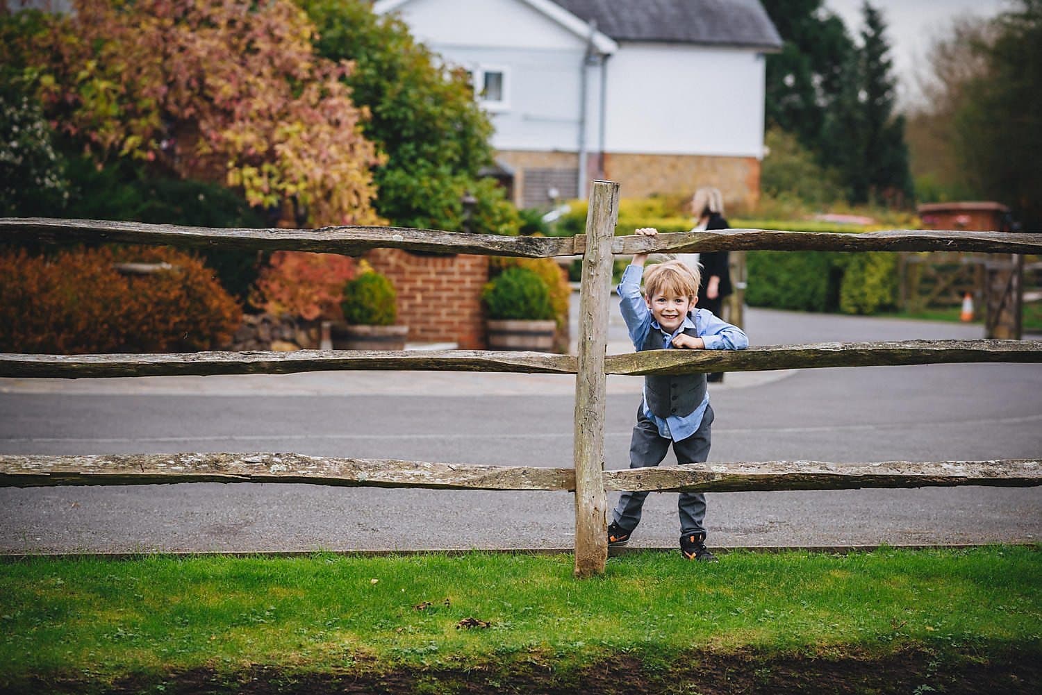 A boy looking through the fence at a wedding