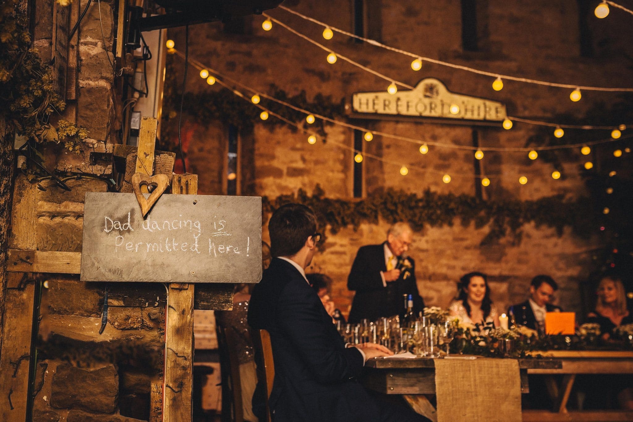 Chalkboard sign 'Dad dancing is permitted here' is displayed next to the top table at Lyde Court