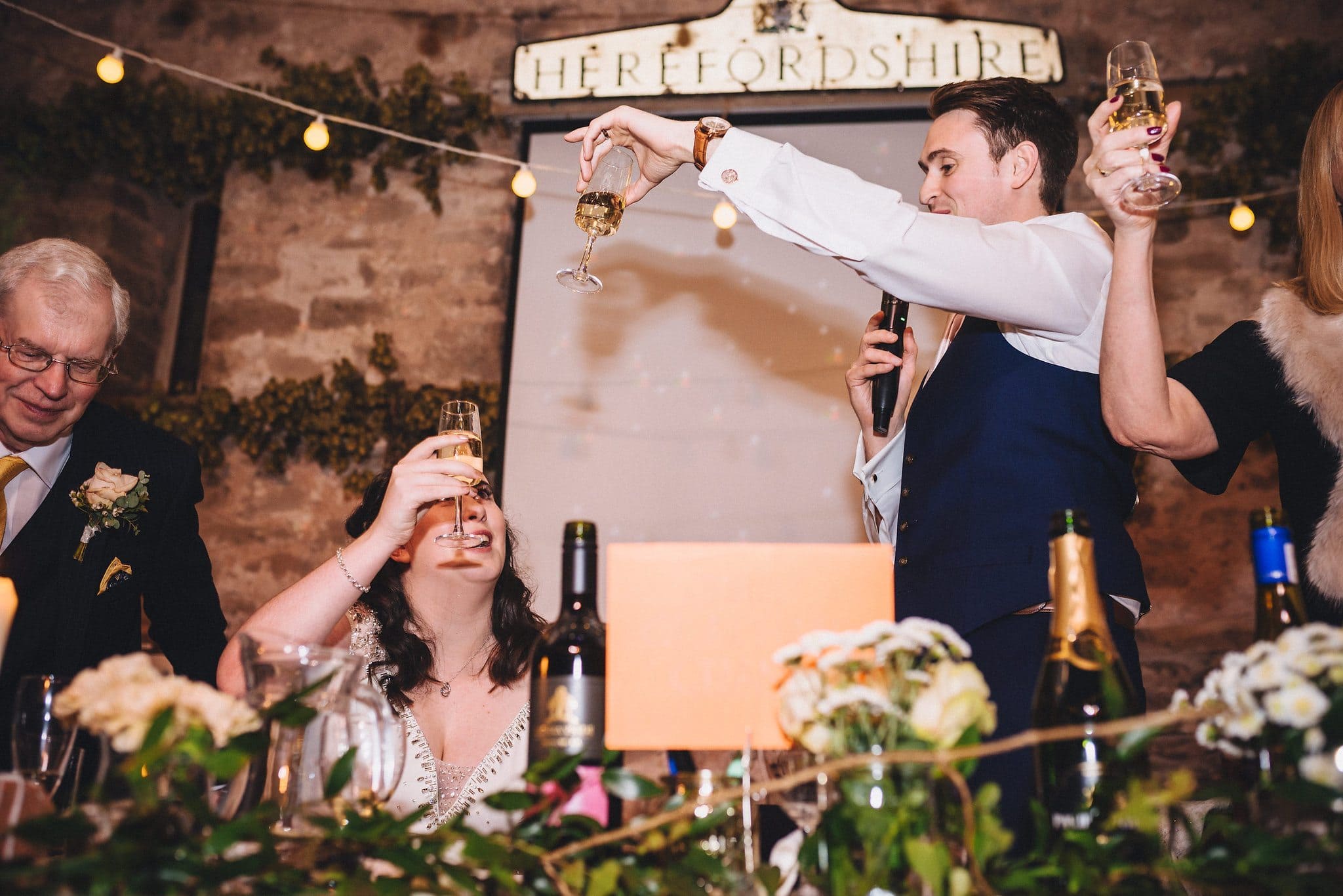 Bride and groom raise glasses to each other