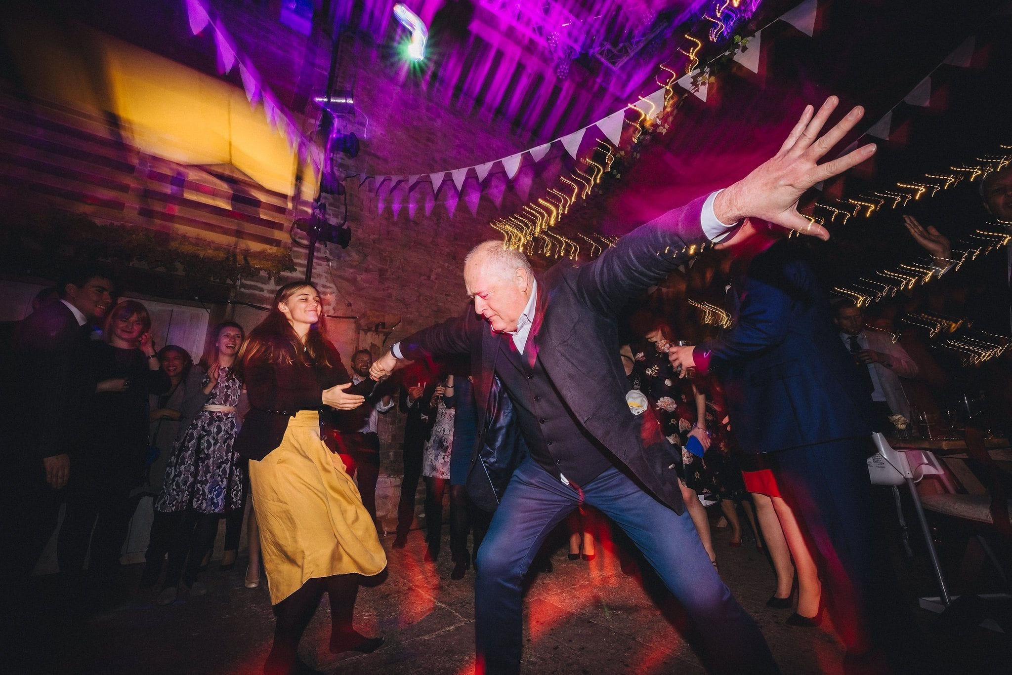 Male guest shows off his moves on the dancefloor at a Lyde Court Winter Wedding