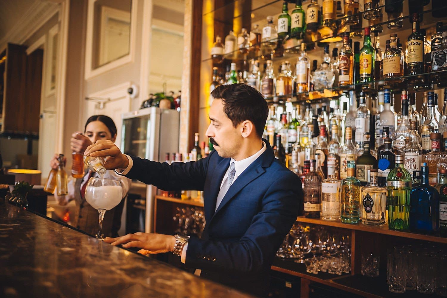 Barman pours a gin and tonic at The Bingham