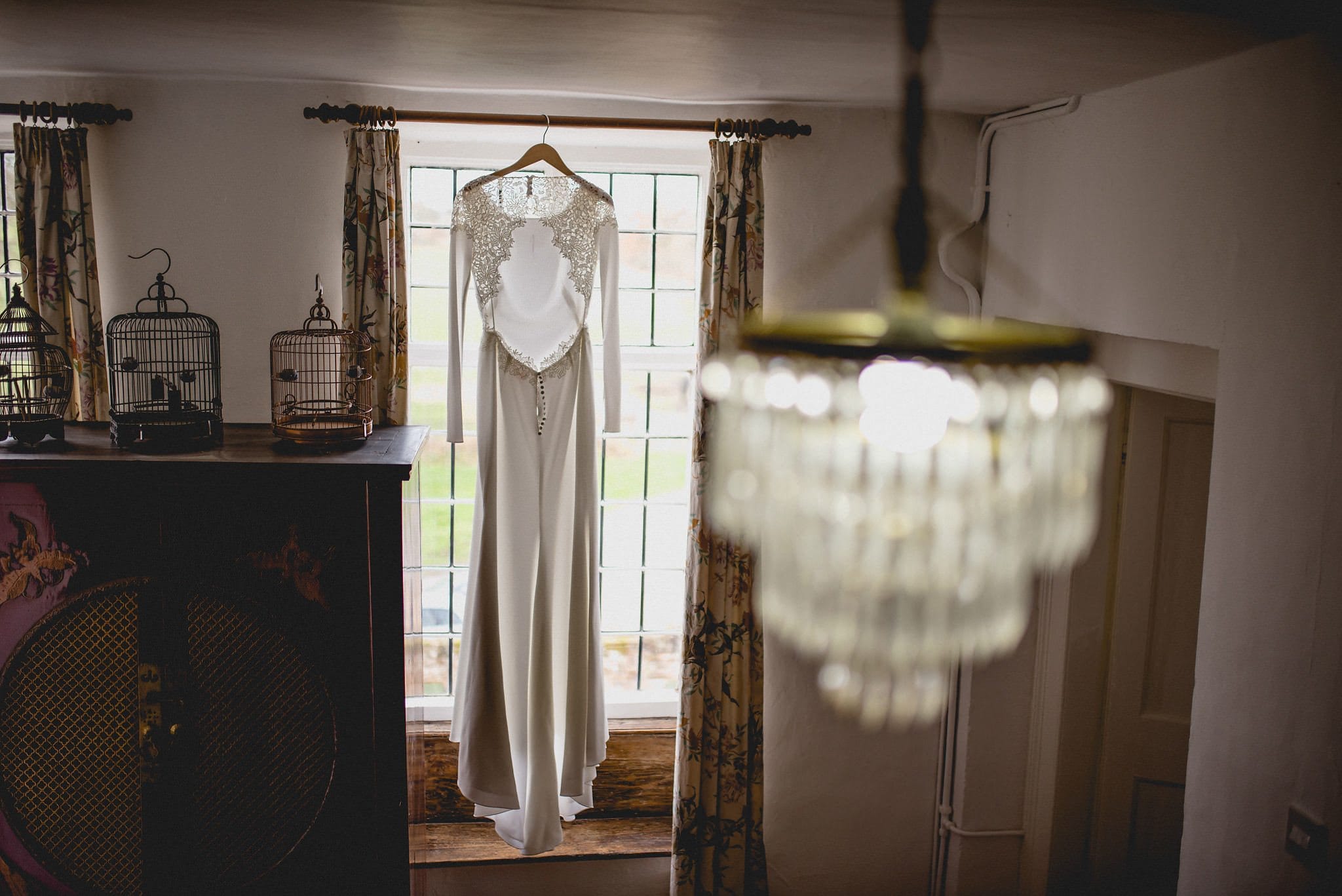 Bride's dress hangs in the window at Littlefield Manor