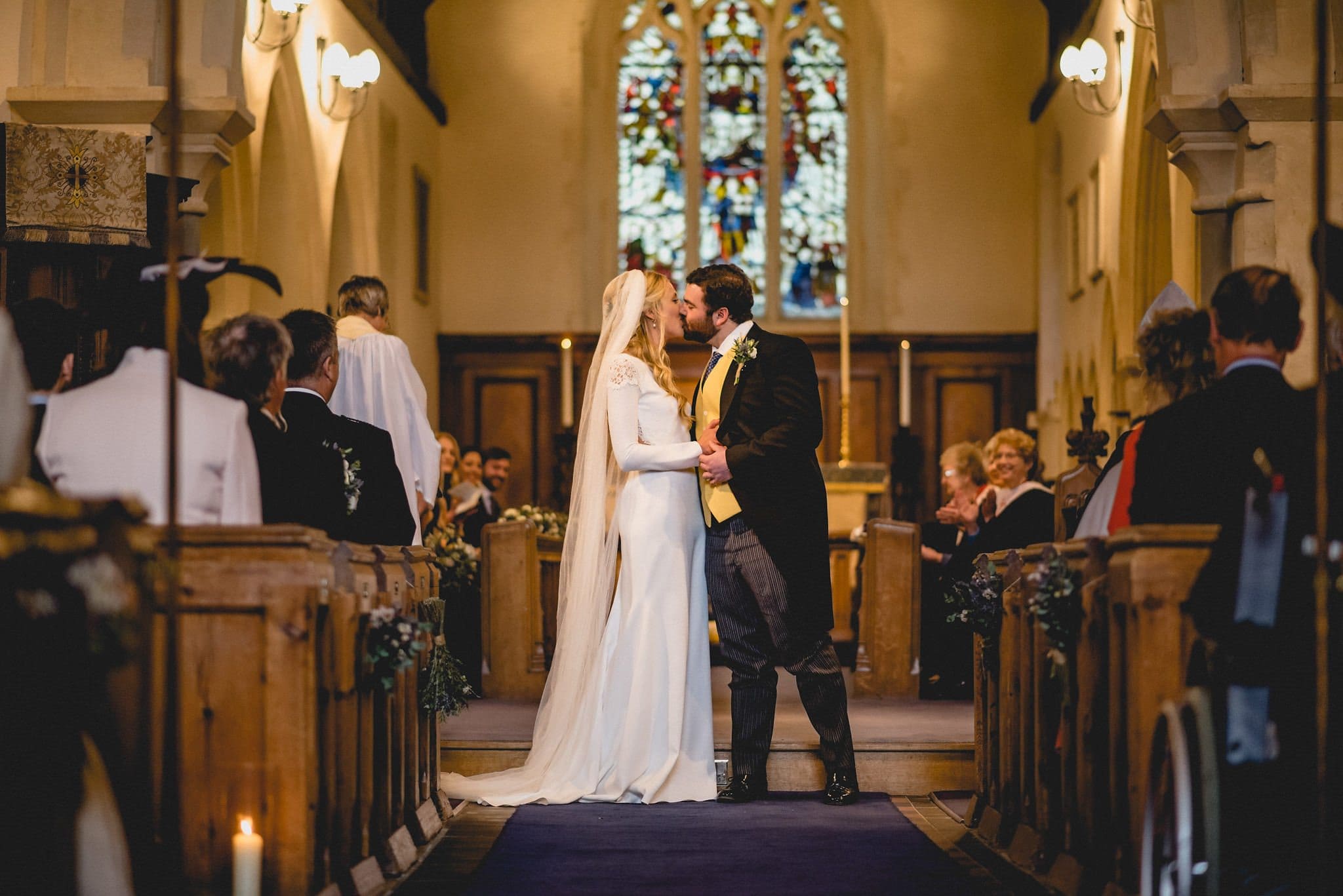 Bride and groom kiss in church