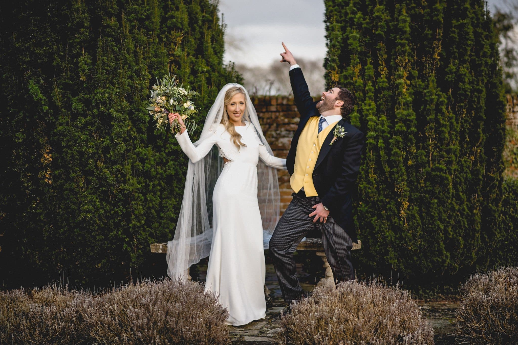 Bride and groom strike silly poses during couple's shoot