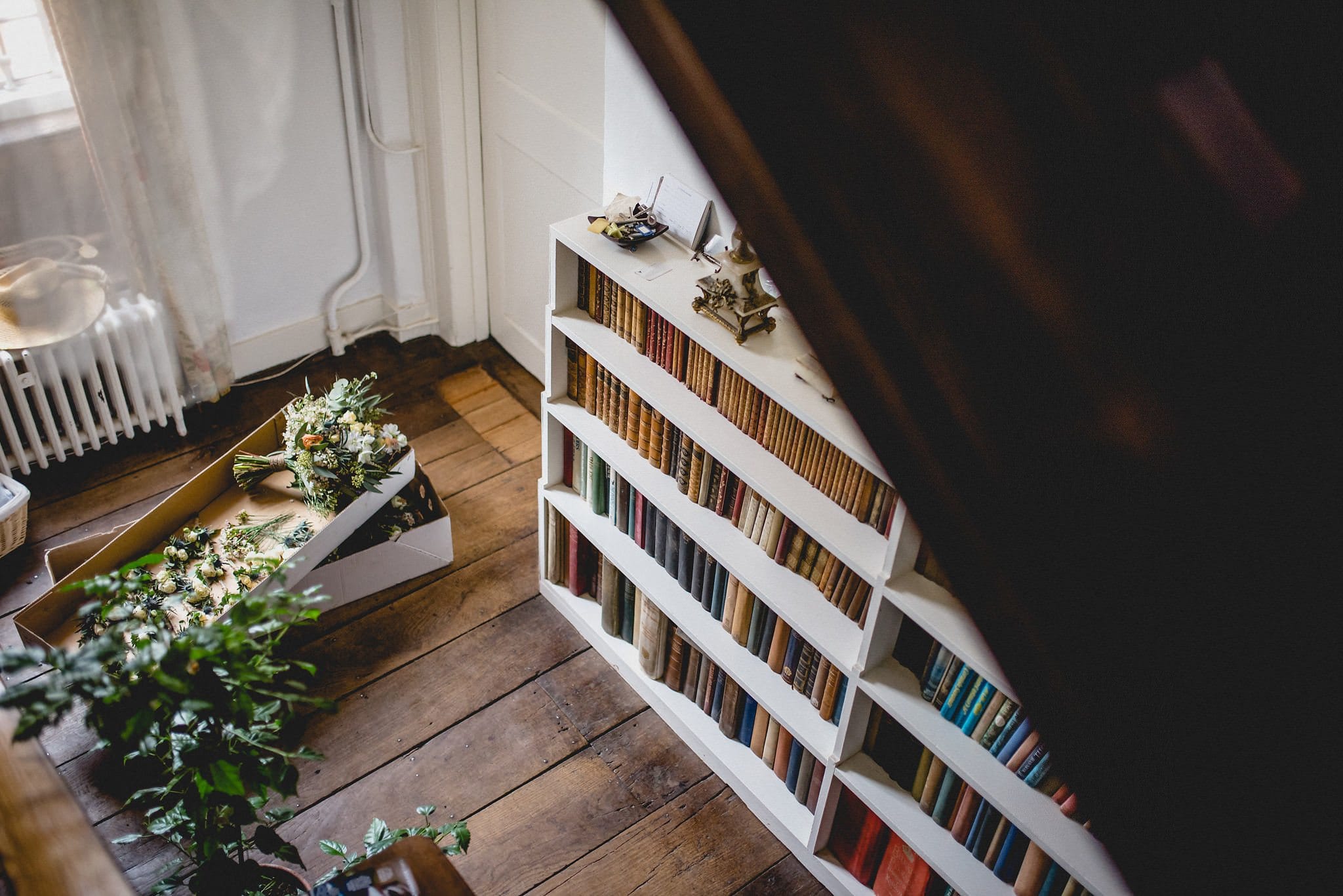 Shot from above of bookshelves and bouquets at Littlefield Manor