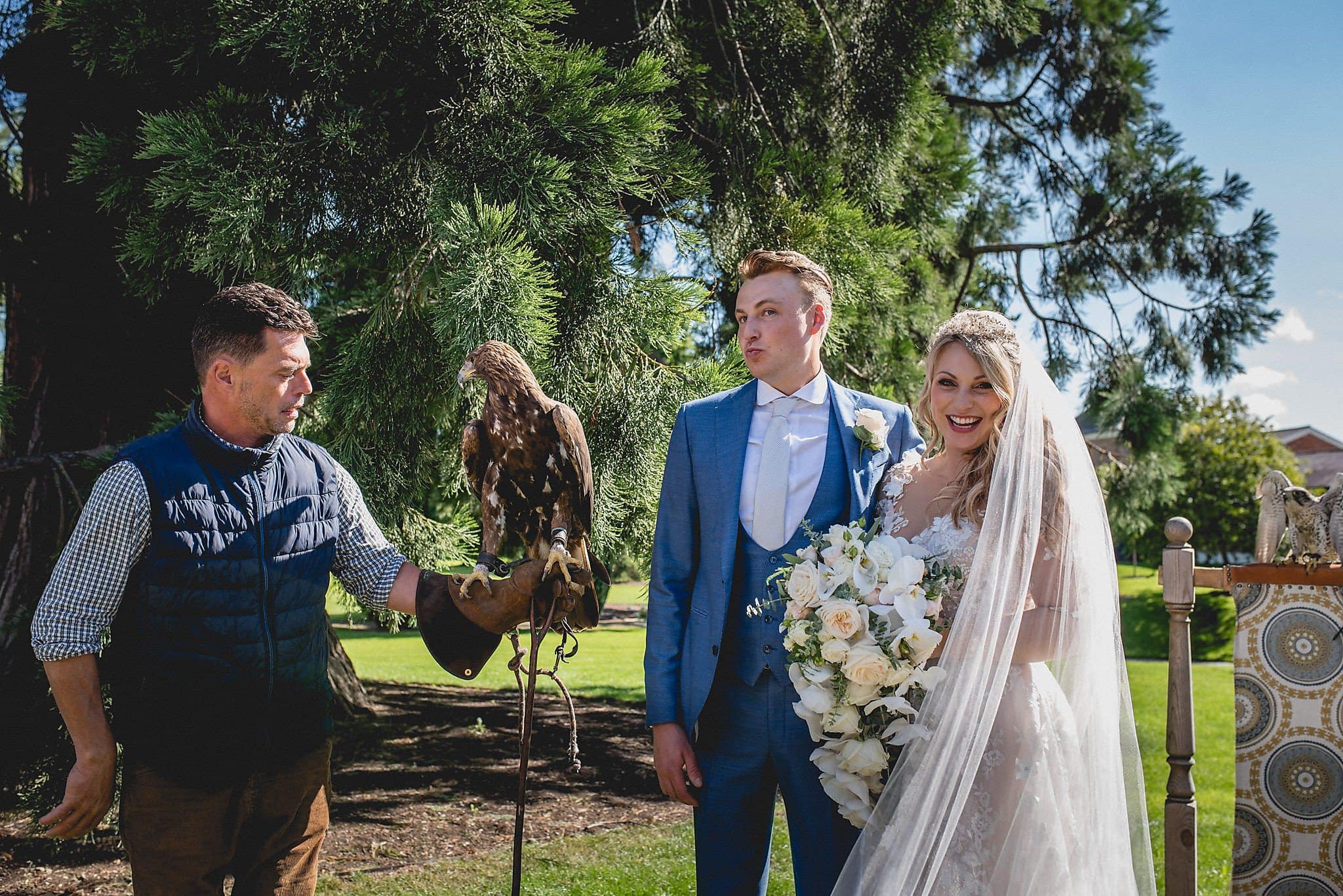 Bride and Groom pose with falcon