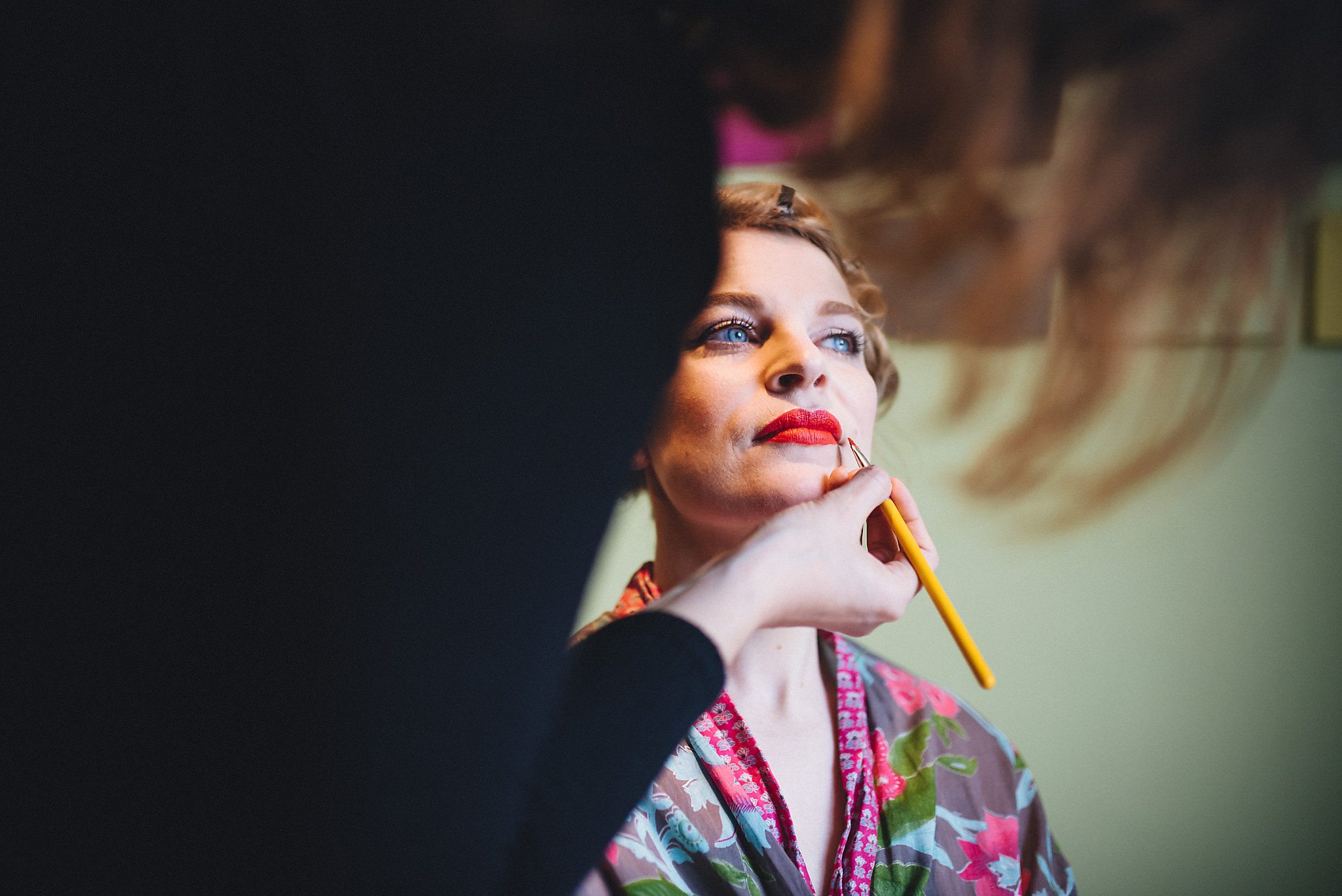 Bride has red lipstick applied as she gets ready for her Londesborough pub wedding