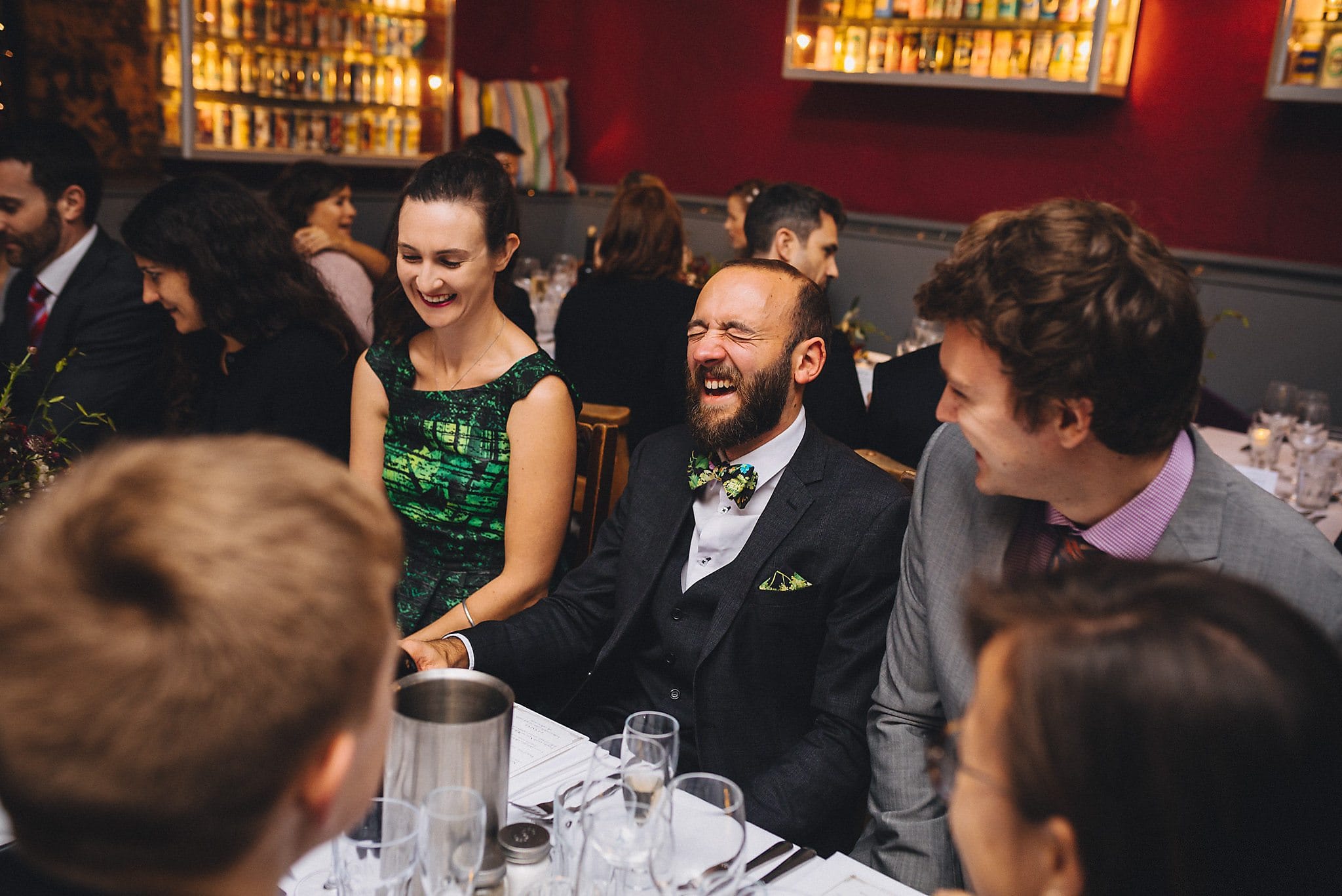 Guests laughing at wedding reception