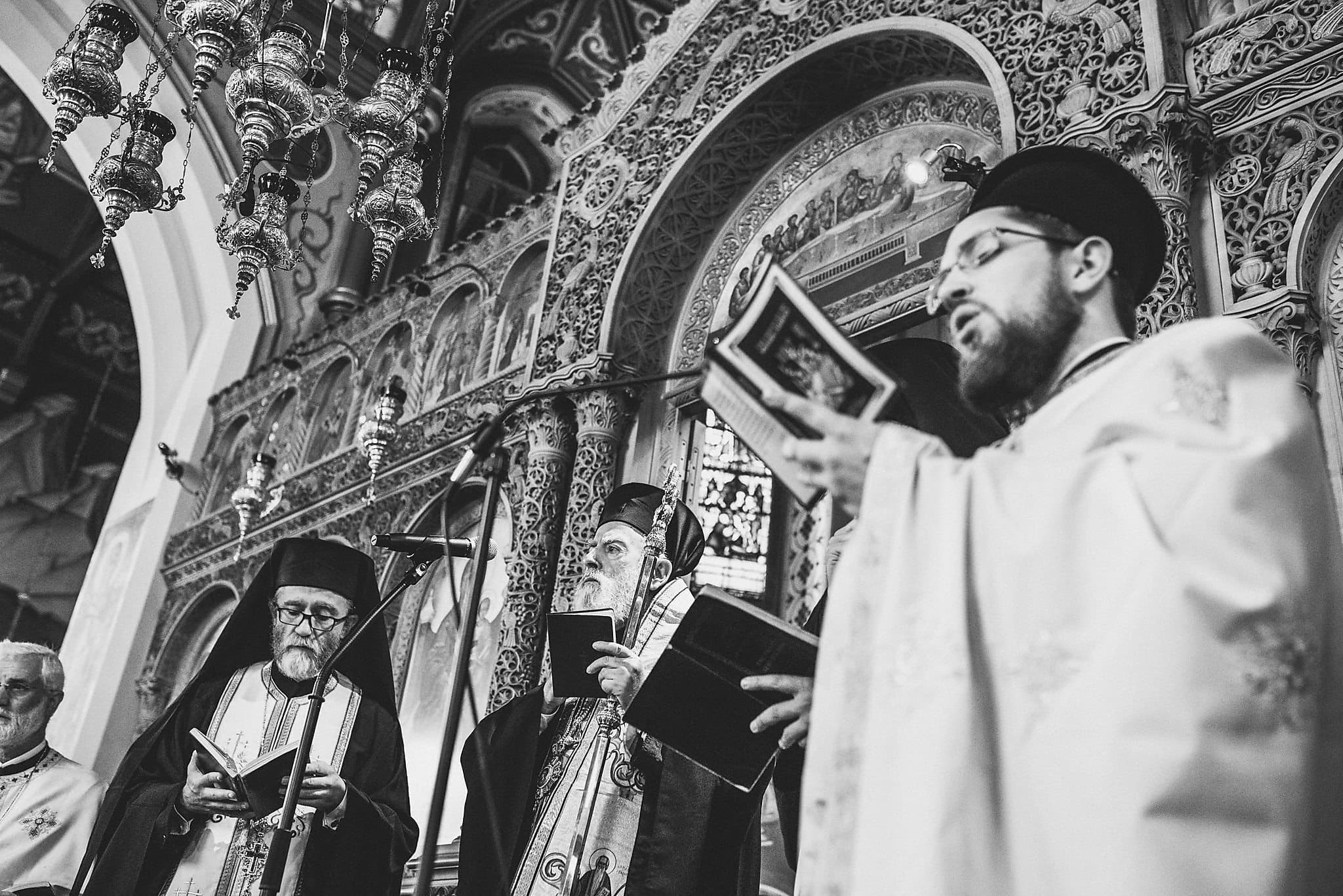 Greek priests sing hymns at a Greek Orthodox Ceremony at London's Saint Andrew's Orthodox Church