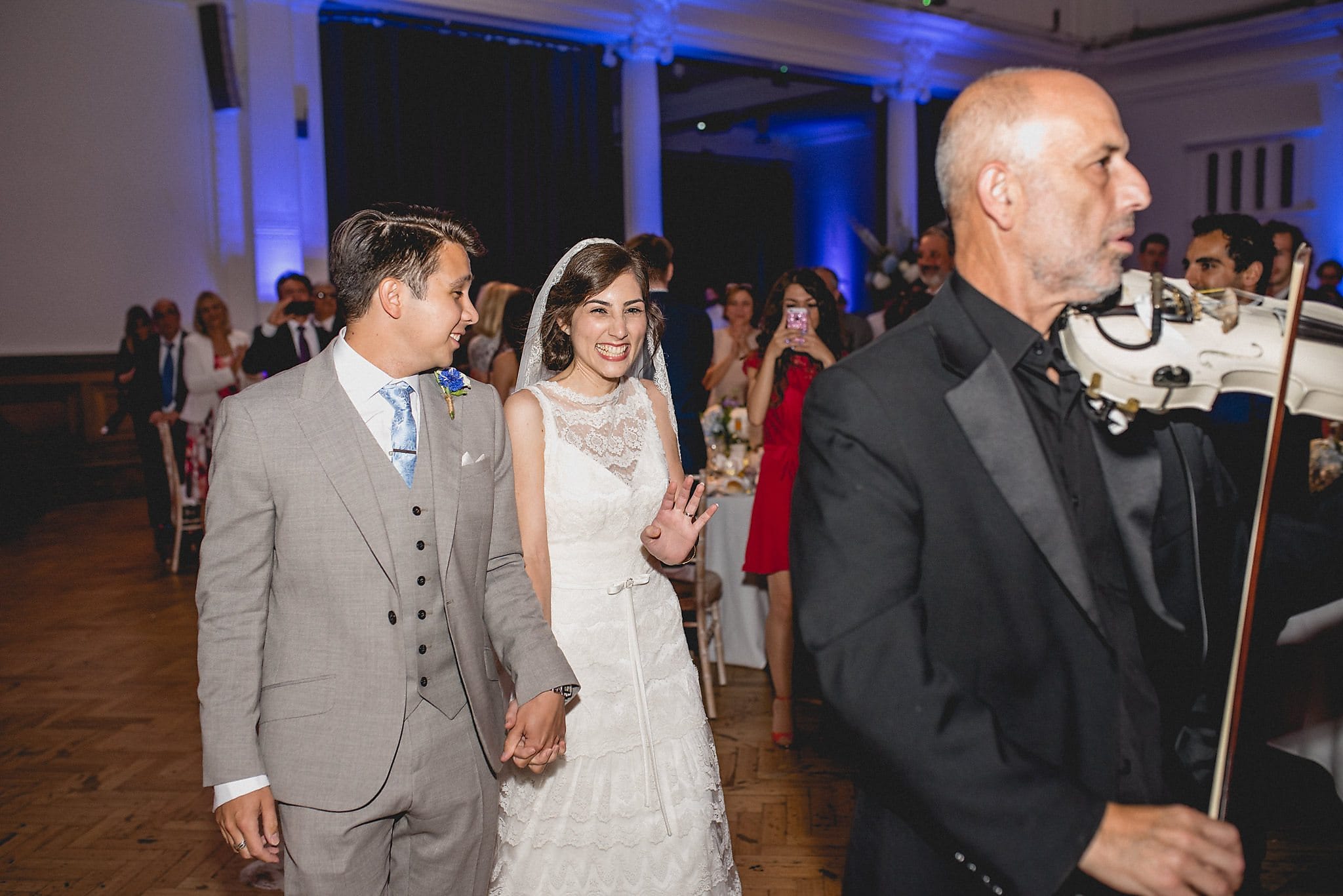 Greek Bride and Groom walk in to a fiddler's music