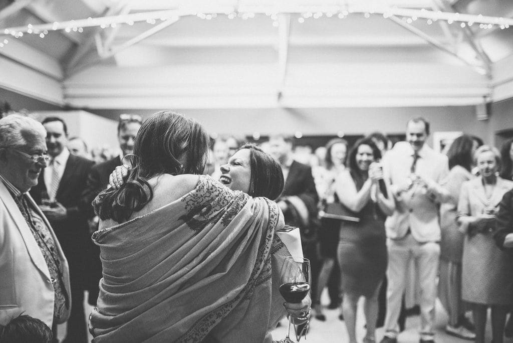 Bride hugs friend after her speech