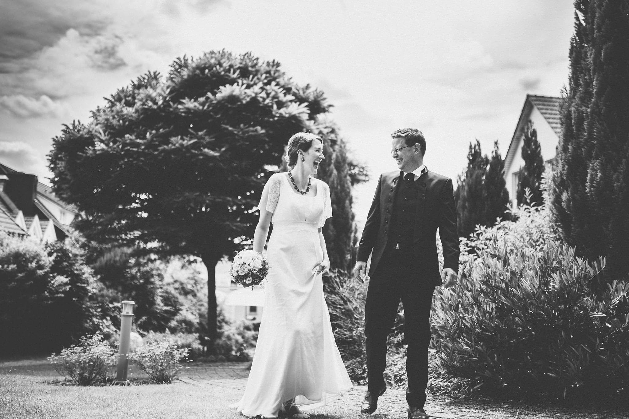 Bride and groom walking and laughing at their Heartfelt Destination Wedding in Germany | Maria Assia Photography